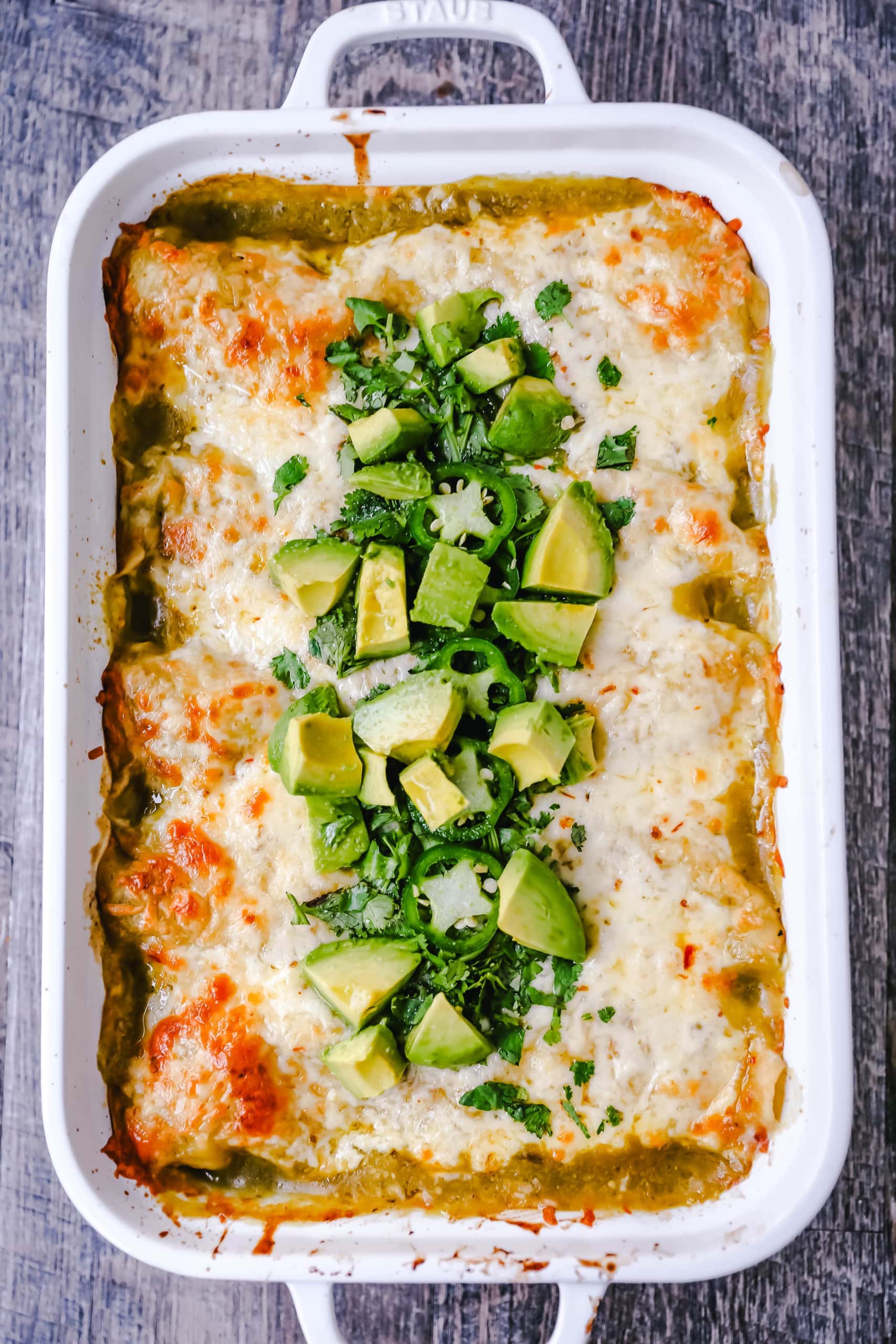 Creamy Green Chile Chicken Enchiladas Creamy chicken enchiladas stuffed with a cream cheese and sour cream green chile chicken rolled into corn tortillas and topped with green enchilada sauce and pepper jack cheese. The best creamy chicken enchiladas recipe! www.moderrnhoney.com #enchiladas #mexicanfood