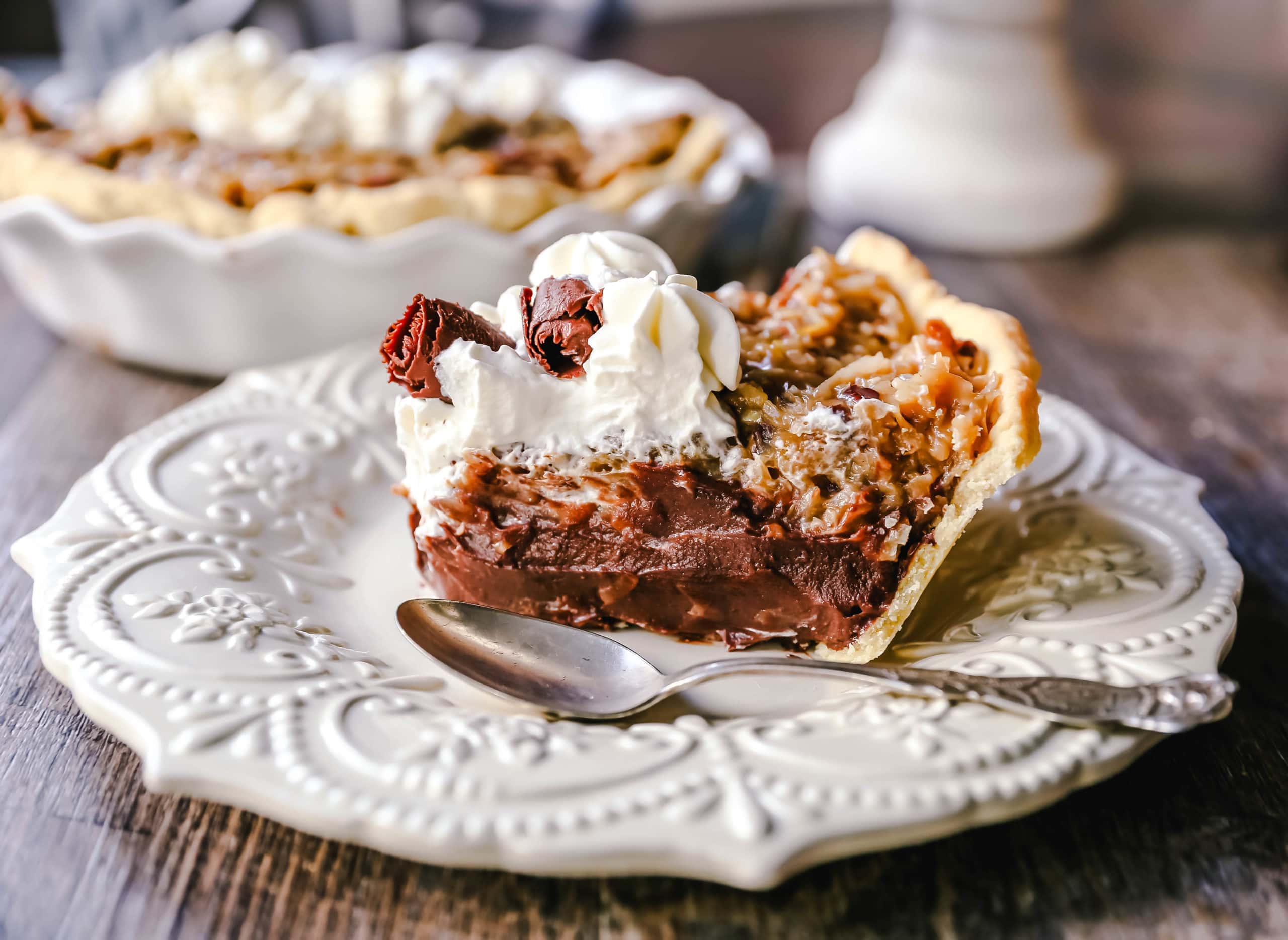 German Chocolate Pie. Creamy rich chocolate pie with a sticky German chocolate coconut-pecan topping and fresh whipped cream and chocolate shavings. www.modernhoney.com #pie #chocolatepie #germanchocolate 