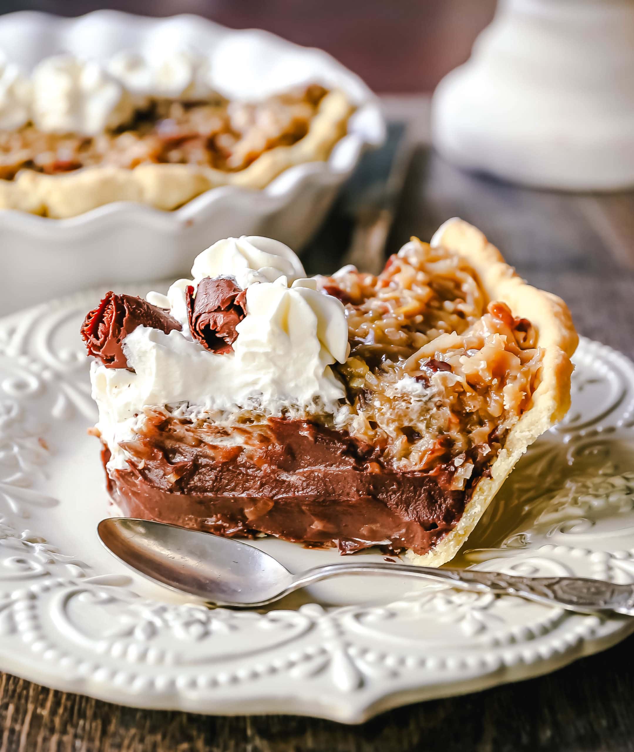 German Chocolate Pie. Creamy rich chocolate pie with a sticky German chocolate coconut-pecan topping and fresh whipped cream and chocolate shavings. www.modernhoney.com #pie #chocolatepie #germanchocolate