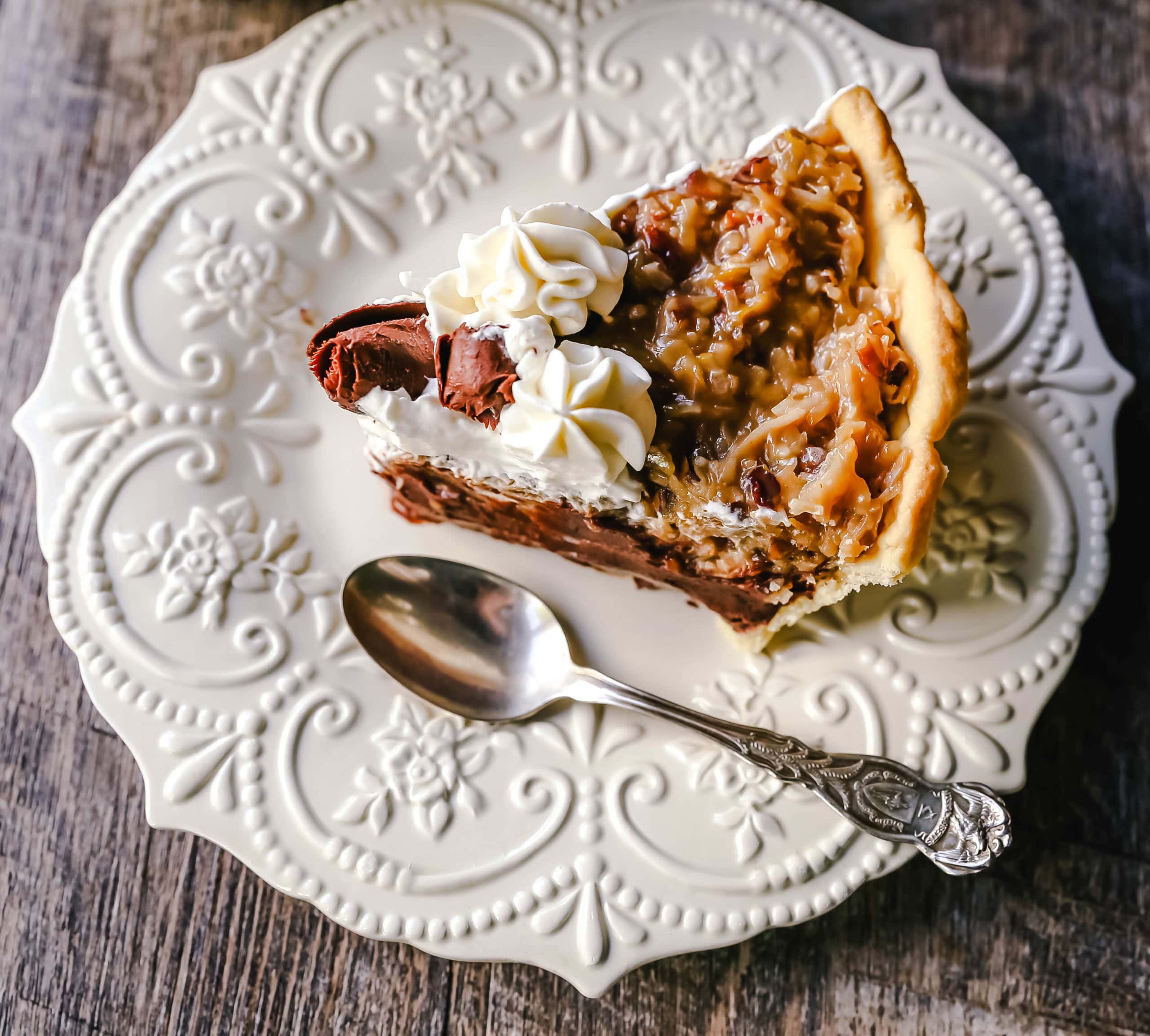 German Chocolate Pie. Creamy rich chocolate pie with a sticky German chocolate coconut-pecan topping and fresh whipped cream and chocolate shavings. www.modernhoney.com #pie #chocolatepie #germanchocolate 