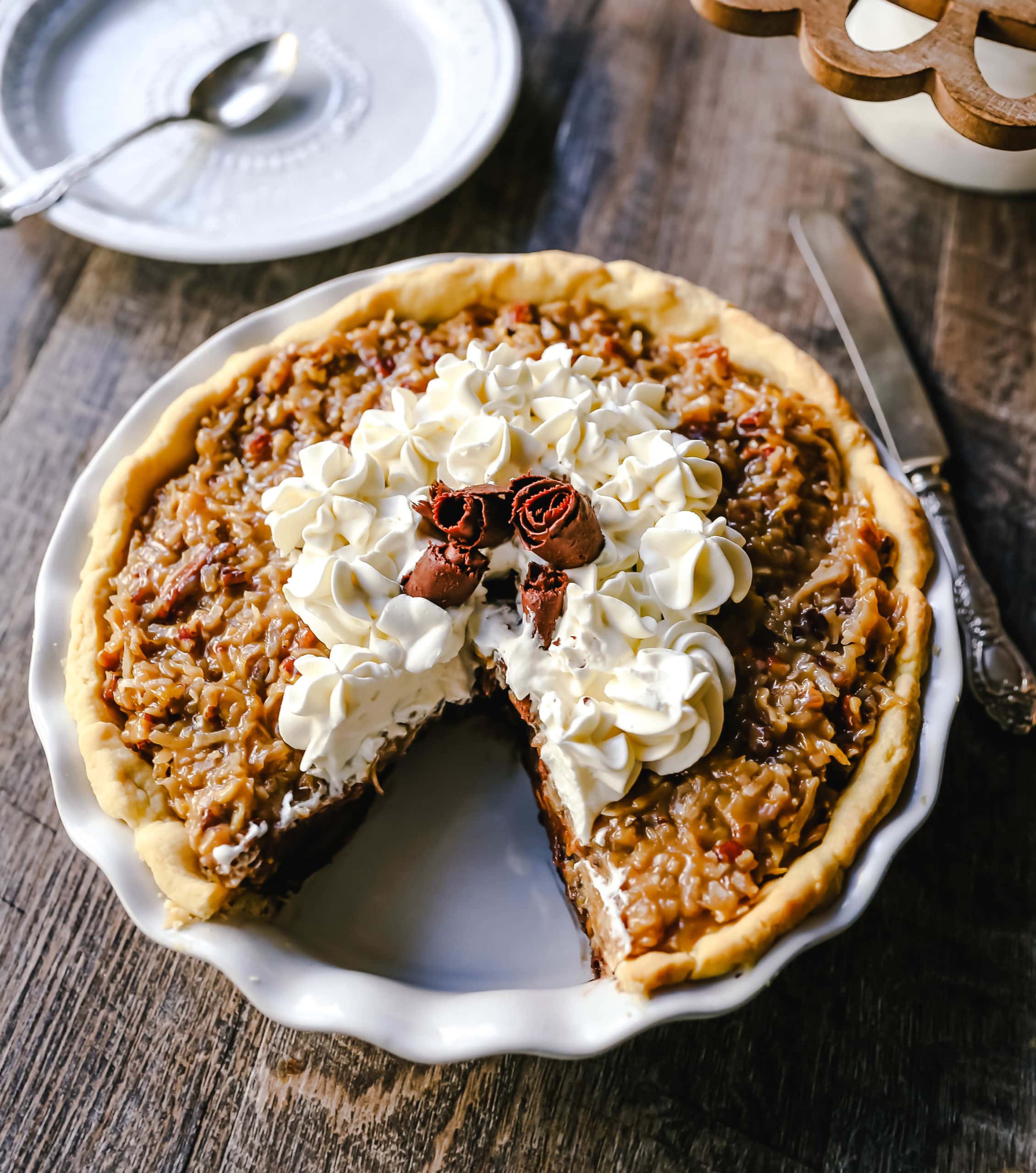 German Chocolate Pie. Creamy rich chocolate pie with a sticky German chocolate coconut-pecan topping and fresh whipped cream and chocolate shavings. www.modernhoney.com #pie #chocolatepie #germanchocolate 