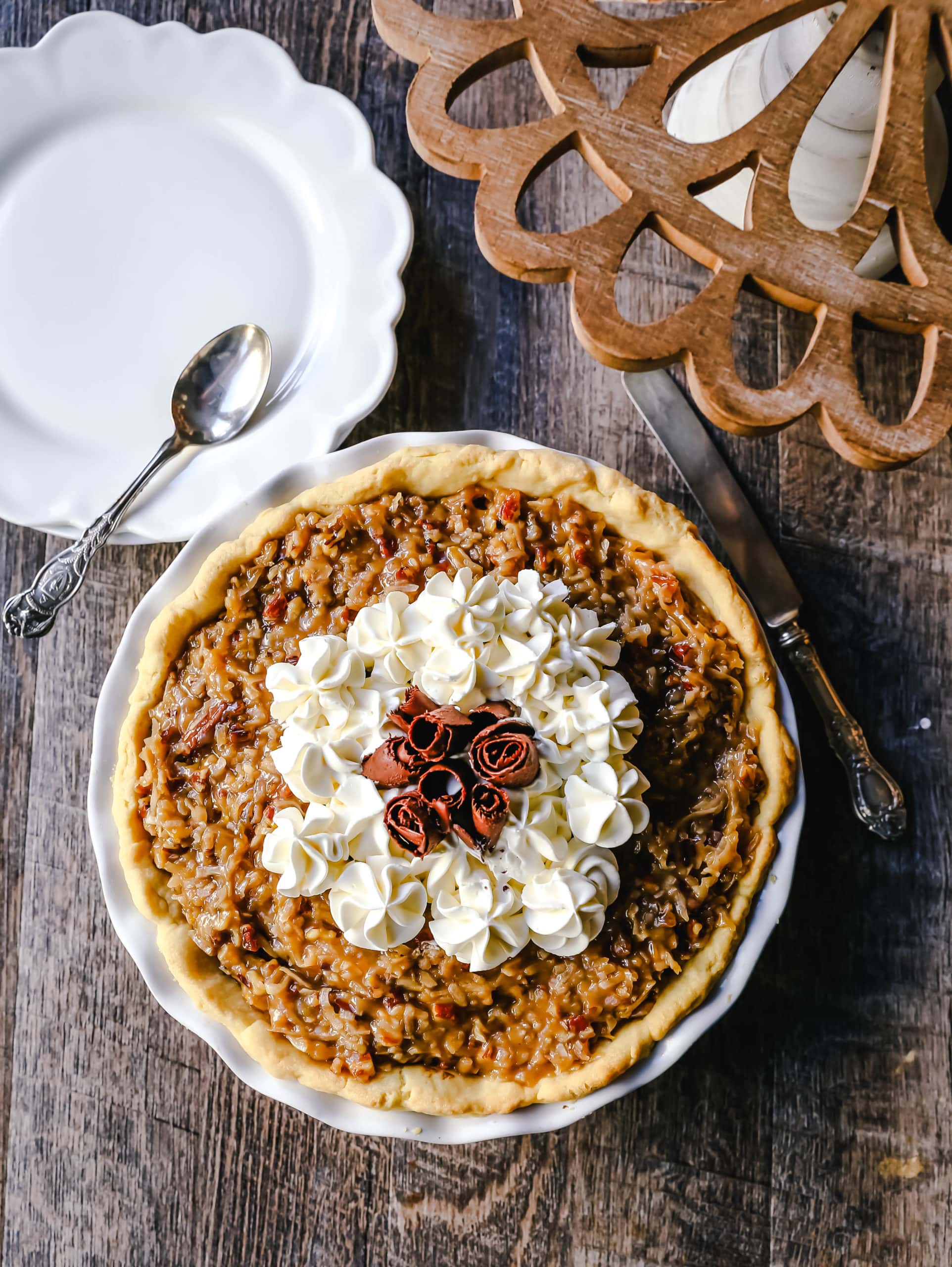 German Chocolate Pie. Creamy rich chocolate pie with a sticky German chocolate coconut-pecan topping and fresh whipped cream and chocolate shavings. www.modernhoney.com #pie #chocolatepie #germanchocolate 