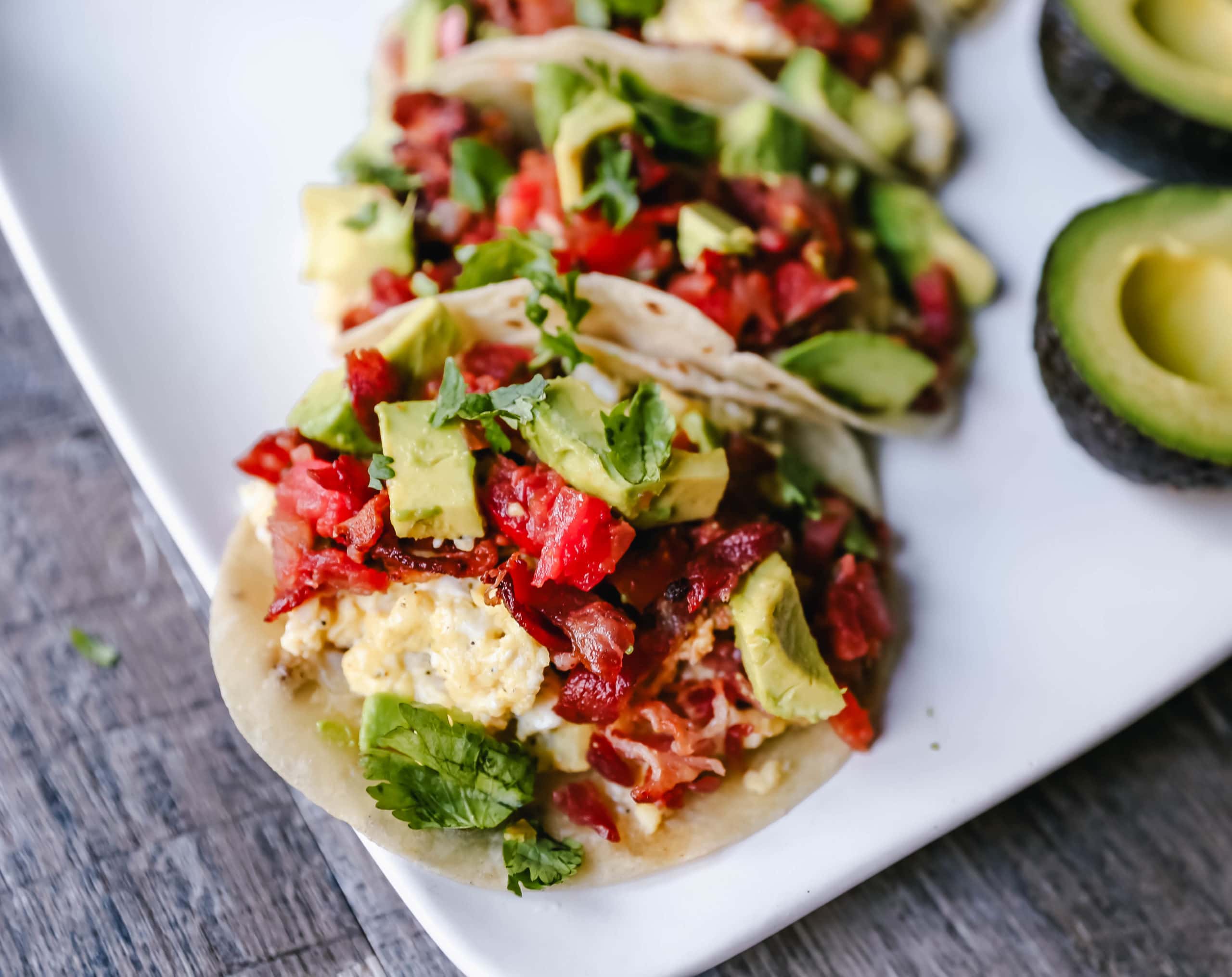 Breakfast Tacos Bacon, Egg, and Cheese Tacos on Flour Tortillas and topped with Fresh Salsa. A Texan favorite breakfast! www.modernhoney.com #tacos #breakfast #breakfasttacos #eggtacos 