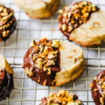 Chocolate-Dipped Pistachio Shortbread Cookies Rich, buttery shortbread butter cookies with crunchy pistachios and dipped in melted chocolate and sprinkled with fresh orange zest and chopped pistachios. A beautiful and festive Christmas cookie! www.modernhoney.com #shortbread #shortbreadcookie #christmascookie #christmascookies