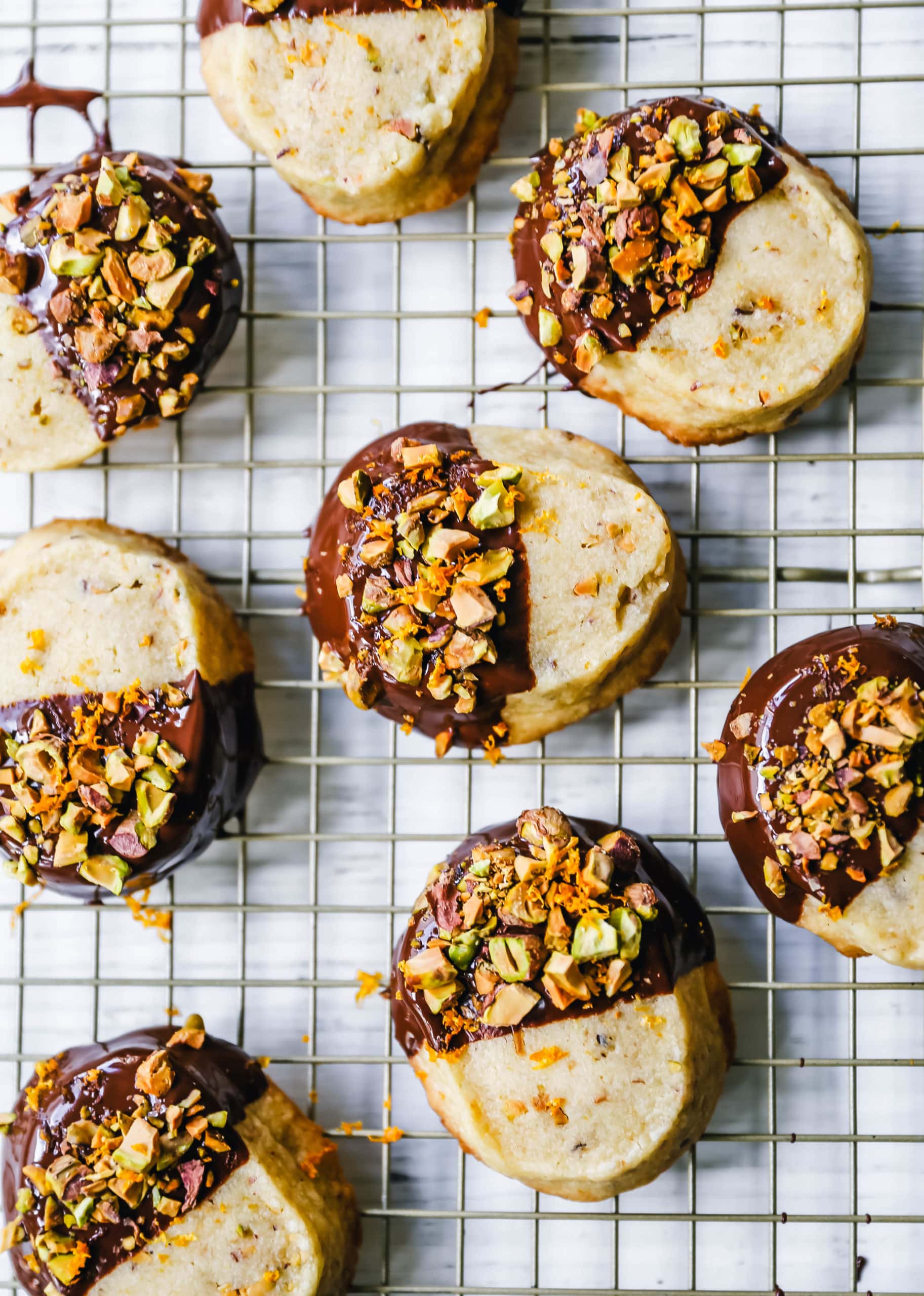 Chocolate-Dipped Pistachio Shortbread Cookies Rich, buttery shortbread butter cookies with crunchy pistachios and dipped in melted chocolate and sprinkled with fresh orange zest and chopped pistachios. A beautiful and festive Christmas cookie! www.modernhoney.com #shortbread #shortbreadcookie #christmascookie #christmascookies