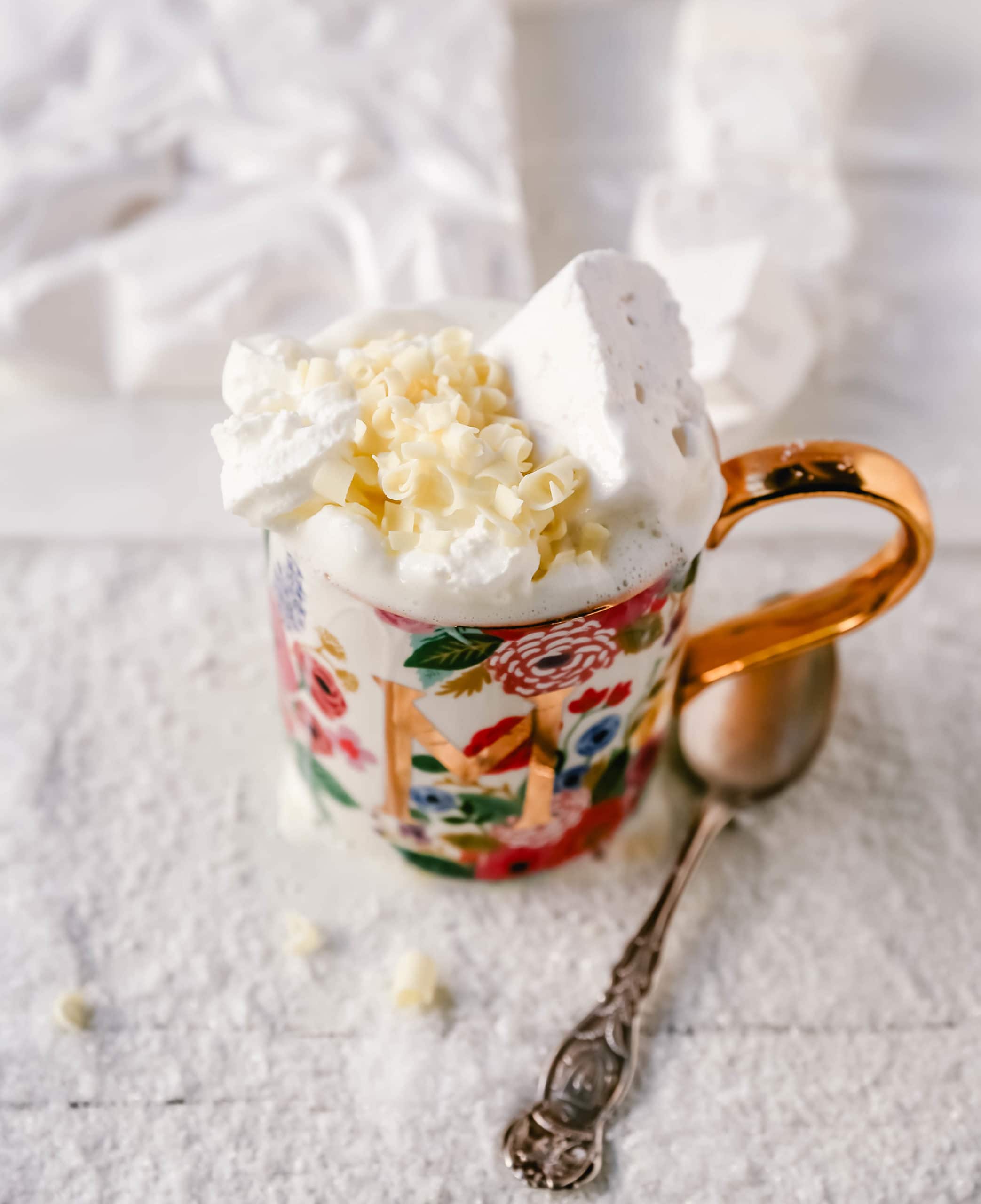 Homemade White Hot Chocolate Creamy, silky-smooth white chocolate made with white chocolate, whole milk, and vanilla beans. Topped with fresh whipped cream, homemade soft marshmallows, and white chocolate shavings. www.modernhoney.com #whitechocolate #hotwhitechocolate #whitehotchocolate 