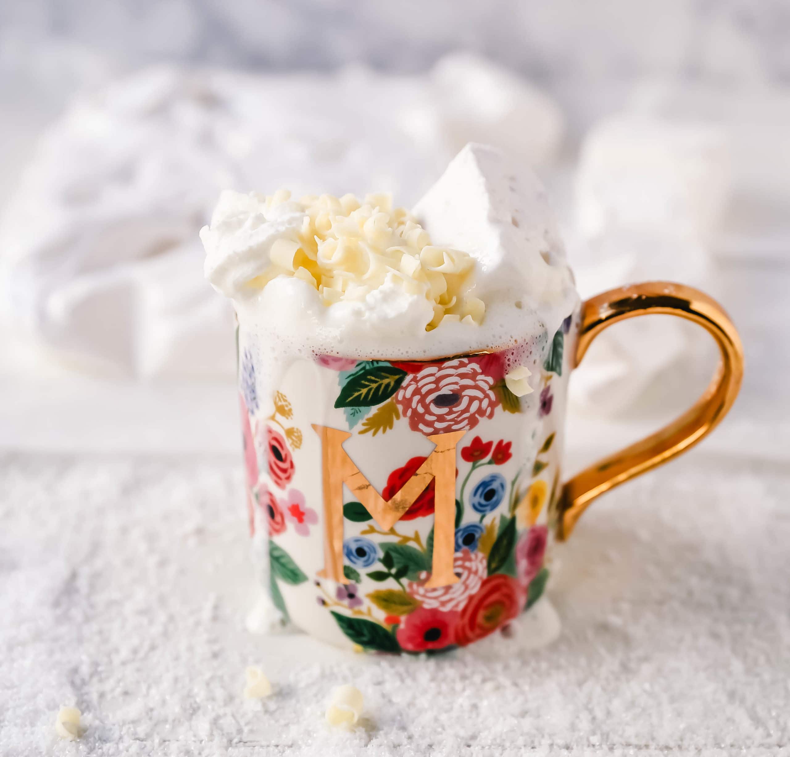 Homemade White Hot Chocolate Creamy, silky-smooth white chocolate made with white chocolate, whole milk, and vanilla beans. Topped with fresh whipped cream, homemade soft marshmallows, and white chocolate shavings. www.modernhoney.com #whitechocolate #hotwhitechocolate #whitehotchocolate 