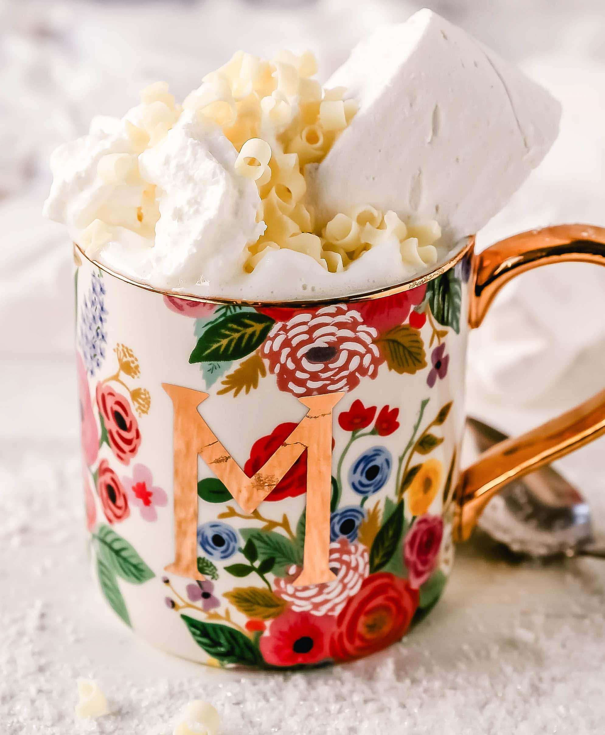 Homemade White Hot Chocolate Creamy, silky-smooth white chocolate made with white chocolate, whole milk, and vanilla beans. Topped with fresh whipped cream, homemade soft marshmallows, and white chocolate shavings. www.modernhoney.com #whitechocolate #hotwhitechocolate #whitehotchocolate 