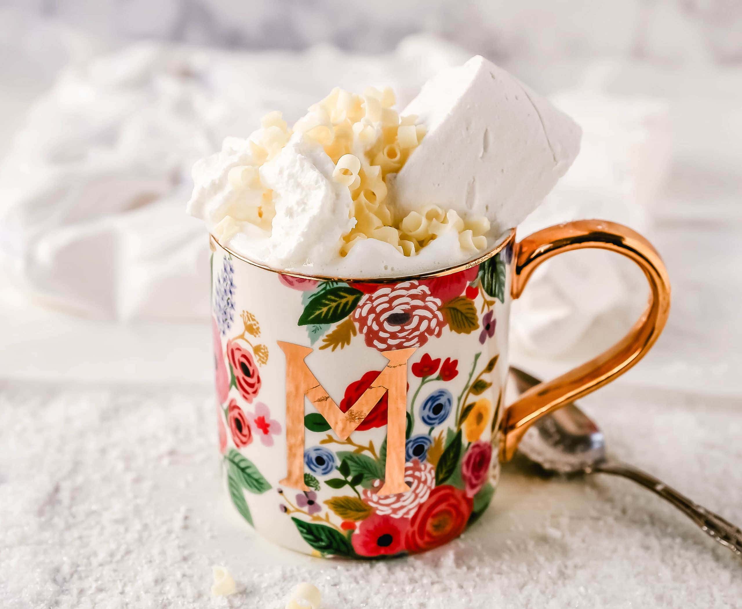 Homemade White Hot Chocolate Creamy, silky-smooth white chocolate made with white chocolate, whole milk, and vanilla beans. Topped with fresh whipped cream, homemade soft marshmallows, and white chocolate shavings. www.modernhoney.com #whitechocolate #hotwhitechocolate #whitehotchocolate 