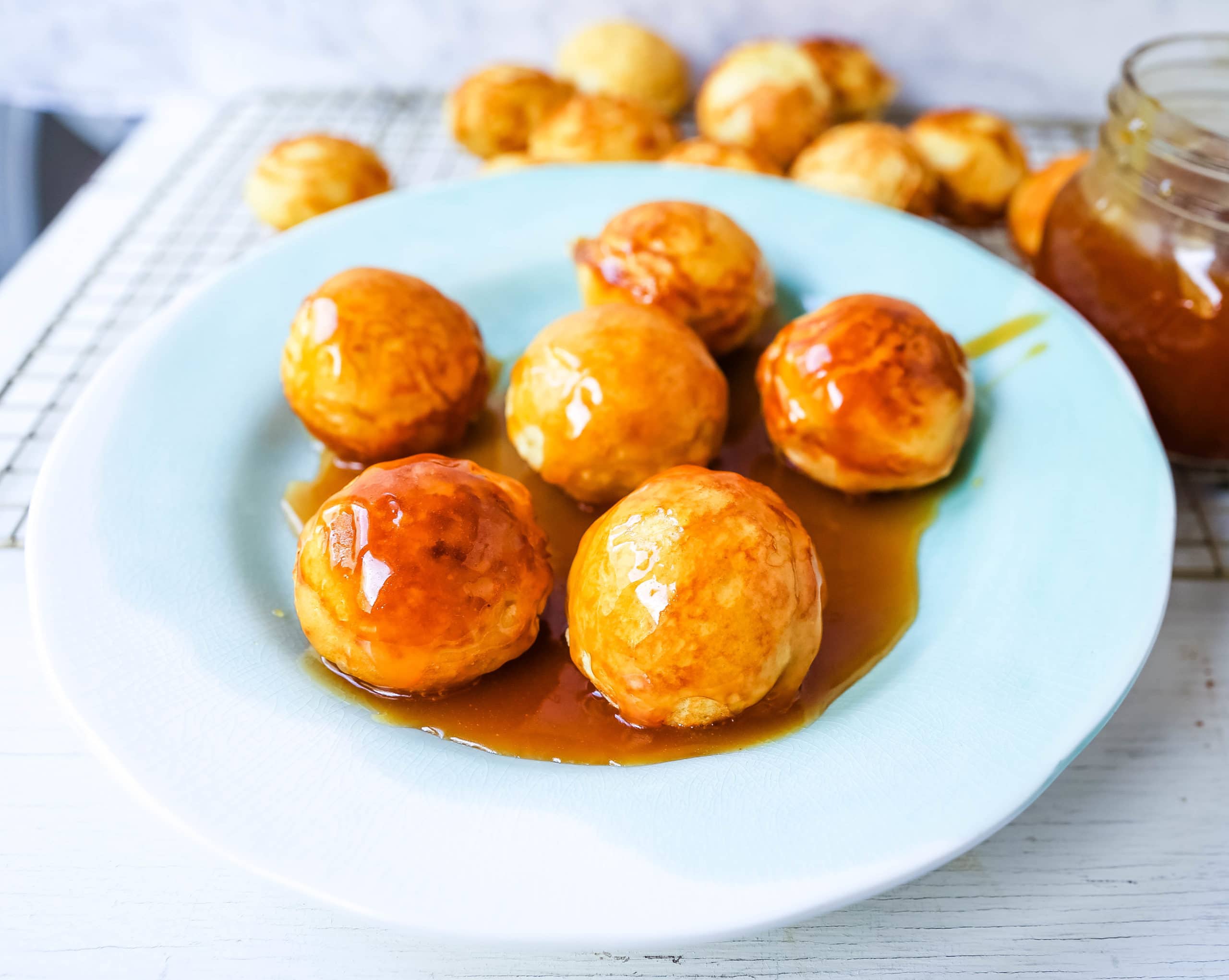 Aebleskiver Danish Pancakes a traditional Danish breakfast or dessert popular in Denmark is a circle pancake cooked in an aebleskiver pan and served with jam, powdered sugar, syrup, and fruit.  www.modernhoney.com #aebleskivers #danishpancakes #pancakes