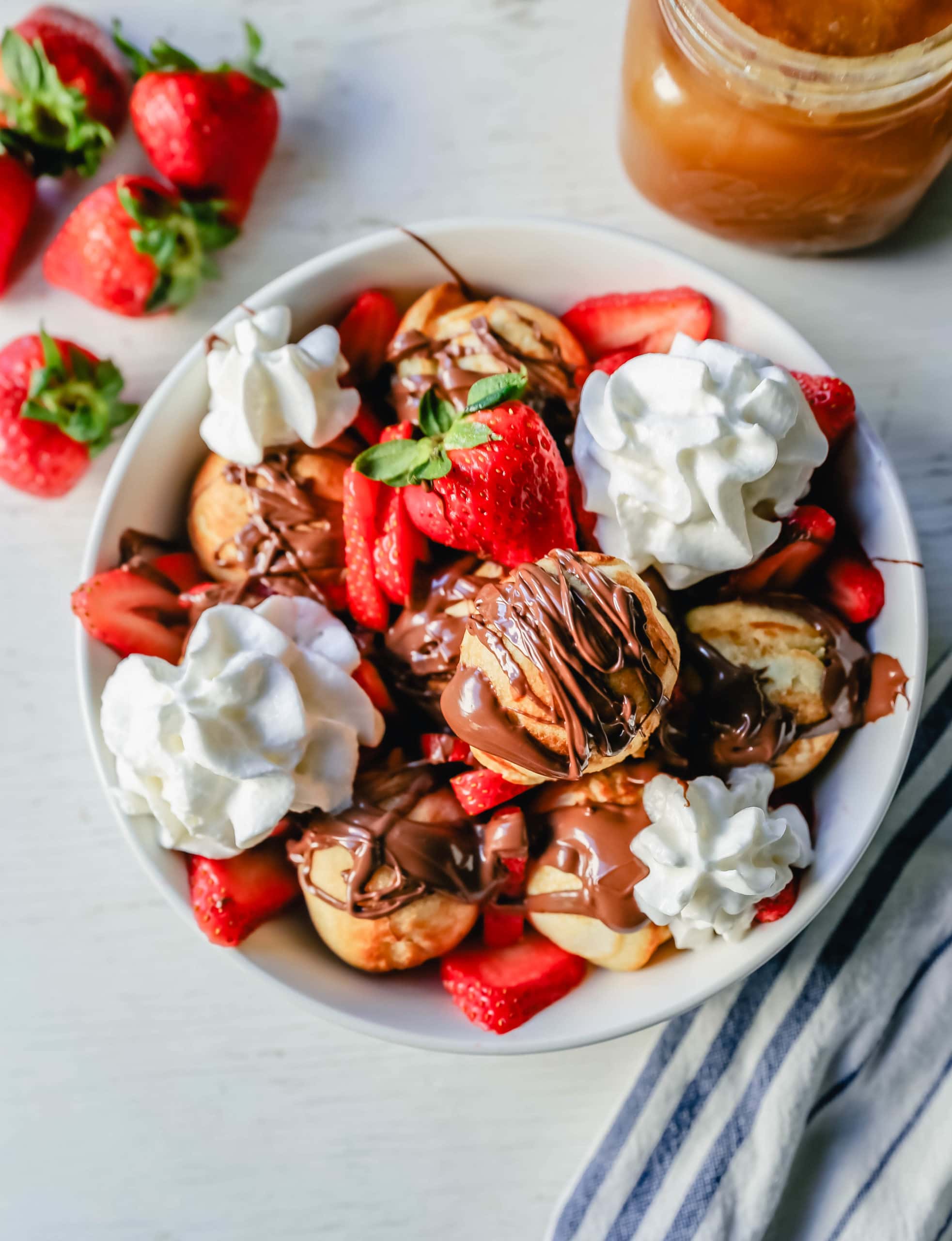 Aebleskiver Danish Pancakes a traditional Danish breakfast or dessert popular in Denmark is a circle pancake cooked in an aebleskiver pan and served with jam, powdered sugar, syrup, and fruit.  www.modernhoney.com #aebleskivers #danishpancakes #pancakes