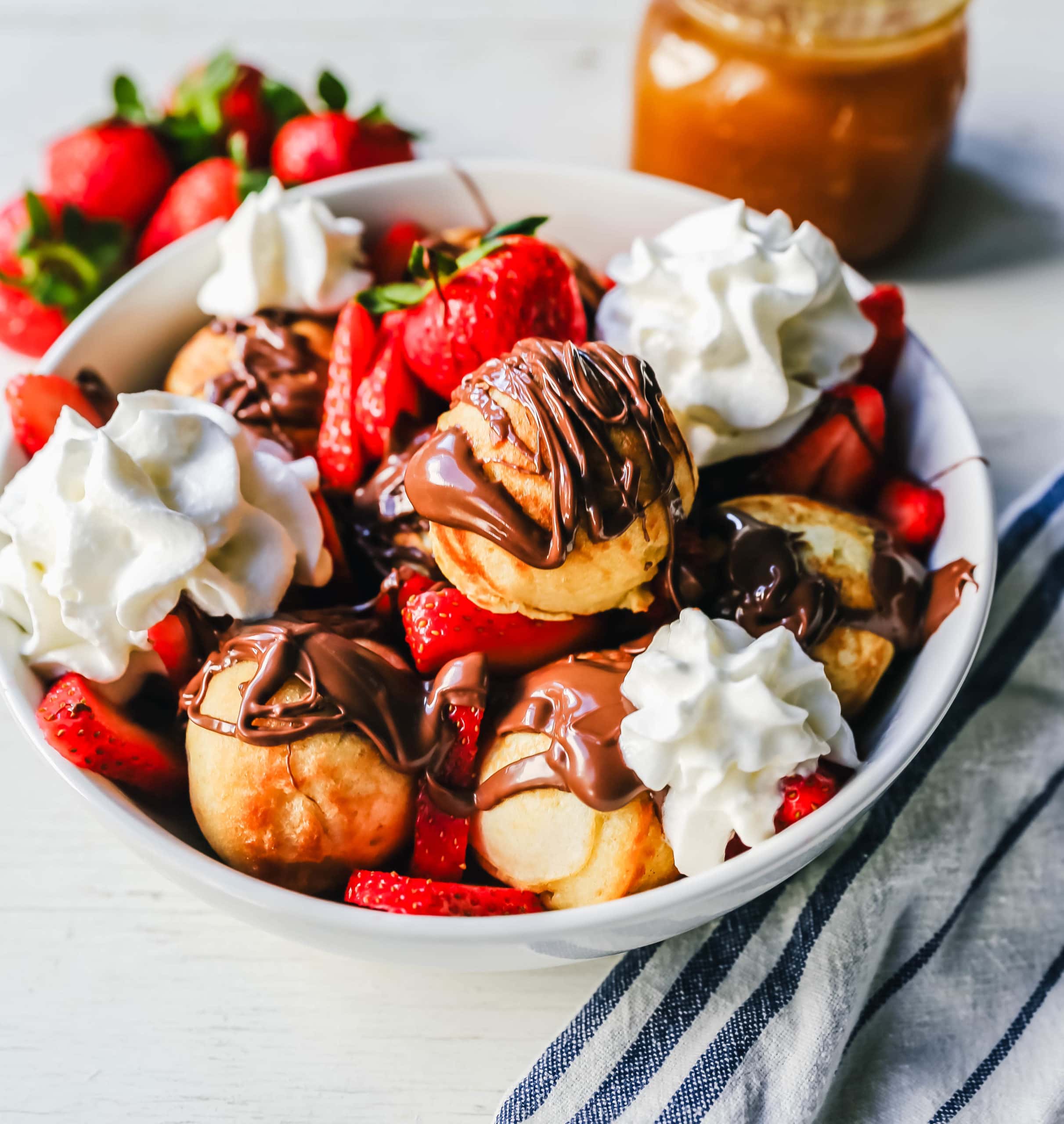 Aebleskiver Danish Pancakes a traditional Danish breakfast or dessert popular in Denmark is a circle pancake cooked in an aebleskiver pan and served with jam, powdered sugar, syrup, and fruit.  www.modernhoney.com #aebleskivers #danishpancakes #pancakes