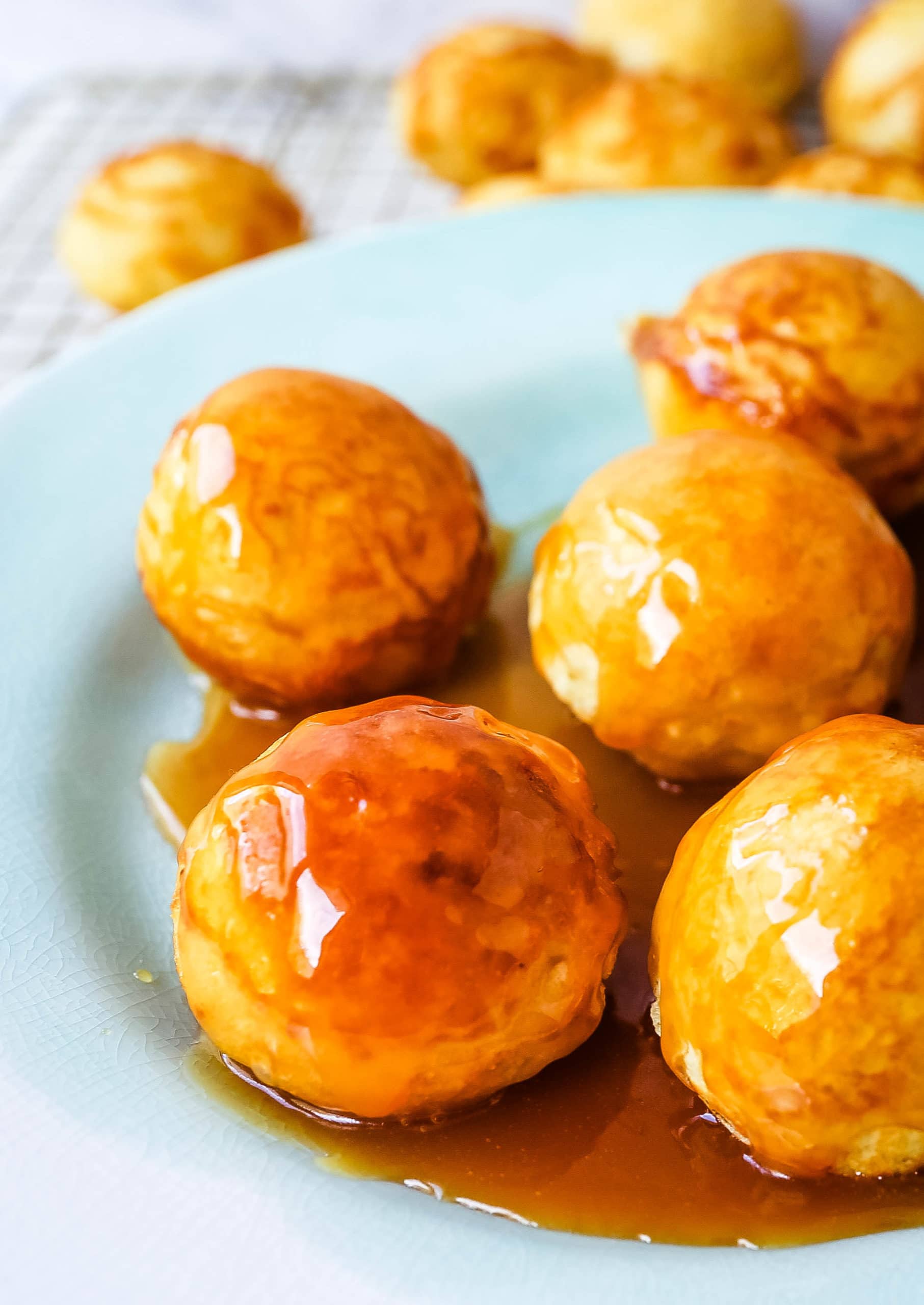 Aebleskiver Danish Pancakes a traditional Danish breakfast or dessert popular in Denmark is a circle pancake cooked in an aebleskiver pan and served with jam, powdered sugar, syrup, and fruit.  www.modernhoney.com #aebleskivers #danishpancakes #pancakes