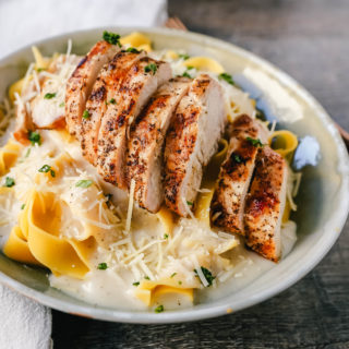 Skinny Low-Fat Chicken Fettuccine Alfredo All of the flavor of Chicken Fettuccine Alfredo without all of the fat and calories! Lean grilled chicken on top of low-fat alfredo sauce tossed with fettuccine noodles. www.modernhoney.com #lowfat #chicken #pasta