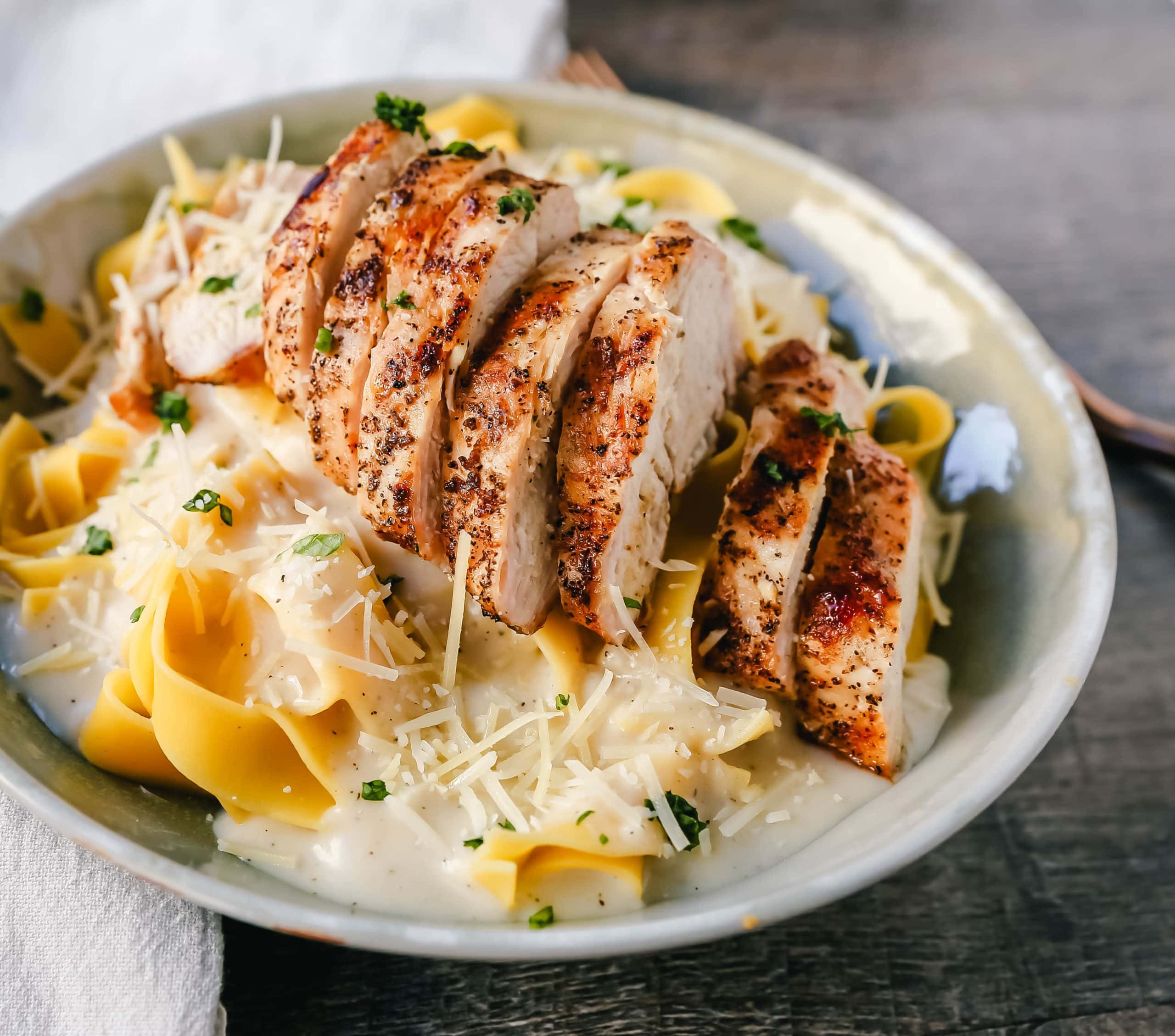 Skinny Low-Fat Chicken Fettuccine Alfredo All of the flavor of Chicken Fettuccine Alfredo without all of the fat and calories! Lean grilled chicken on top of low-fat alfredo sauce tossed with fettuccine noodles. www.modernhoney.com #lowfat #chicken #pasta