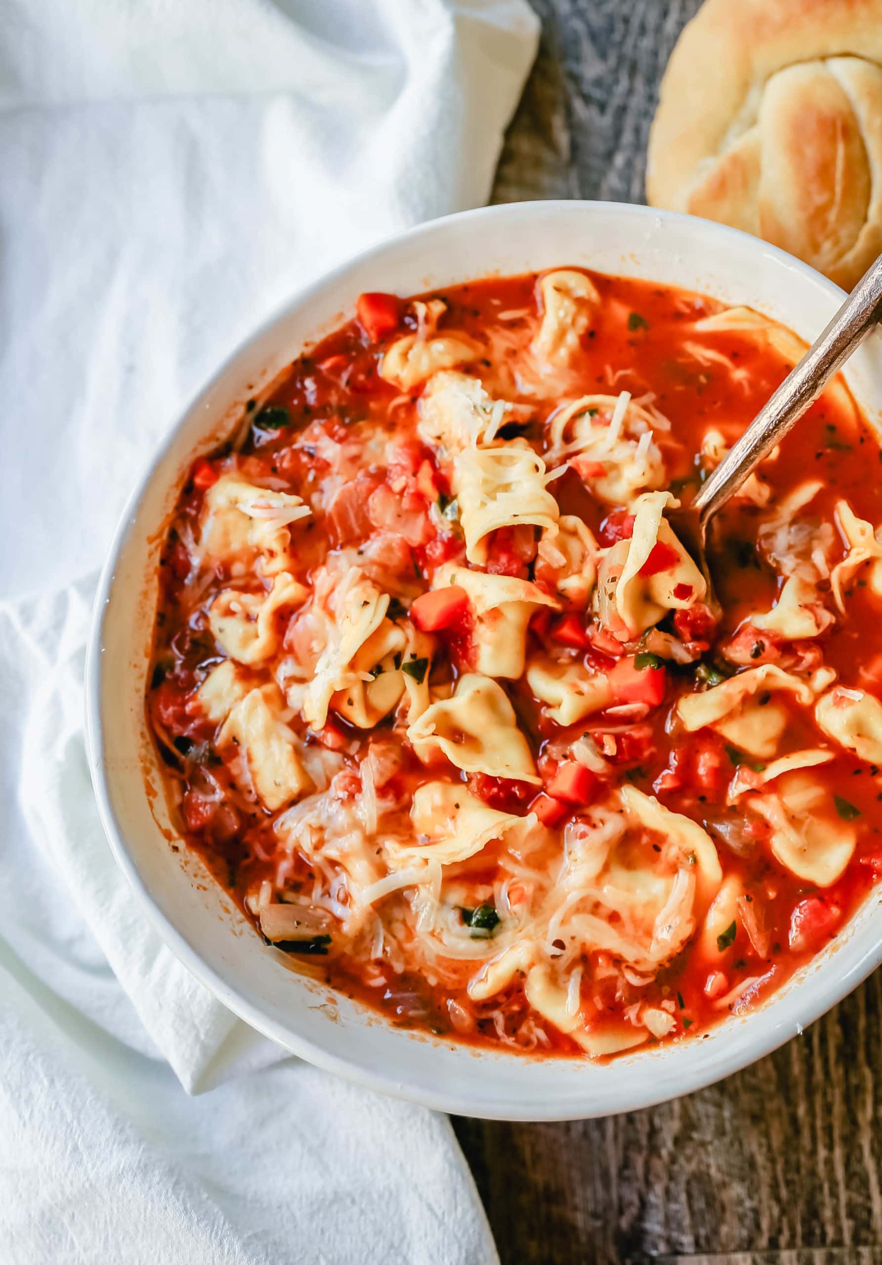 Tuscan Tortellini Vegetable Soup Robust vegetable soup with onions, garlic, carrots, tomatoes, basil, oregano, in a warm broth with creamy cheese tortellini and fresh parmesan cheese. The best tortellini soup! www.modernhoney.com #soup #tortellinisoup