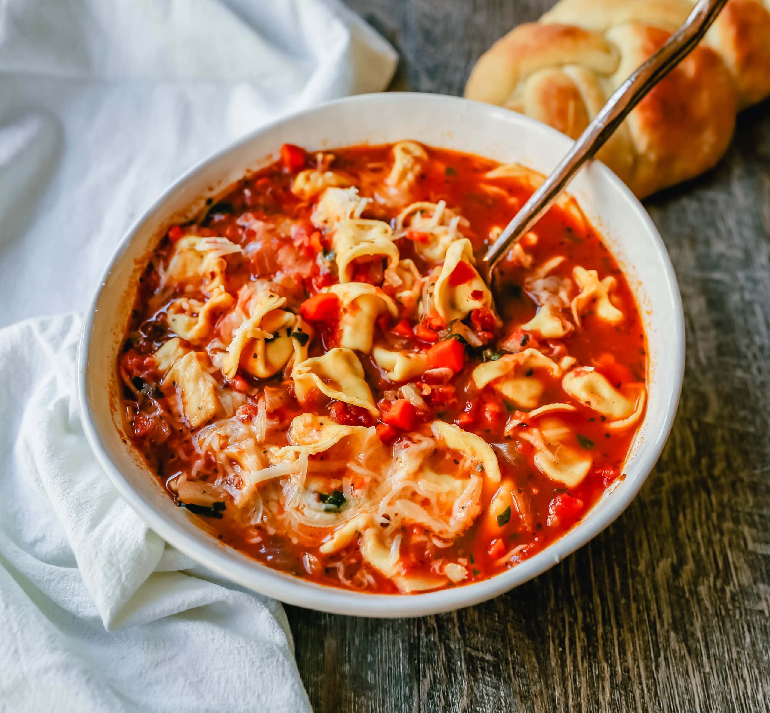 Tuscan Tortellini Vegetable Soup Robust vegetable soup with onions, garlic, carrots, tomatoes, basil, oregano, in a warm broth with creamy cheese tortellini and fresh parmesan cheese. The best tortellini soup! www.modernhoney.com #soup #tortellinisoup