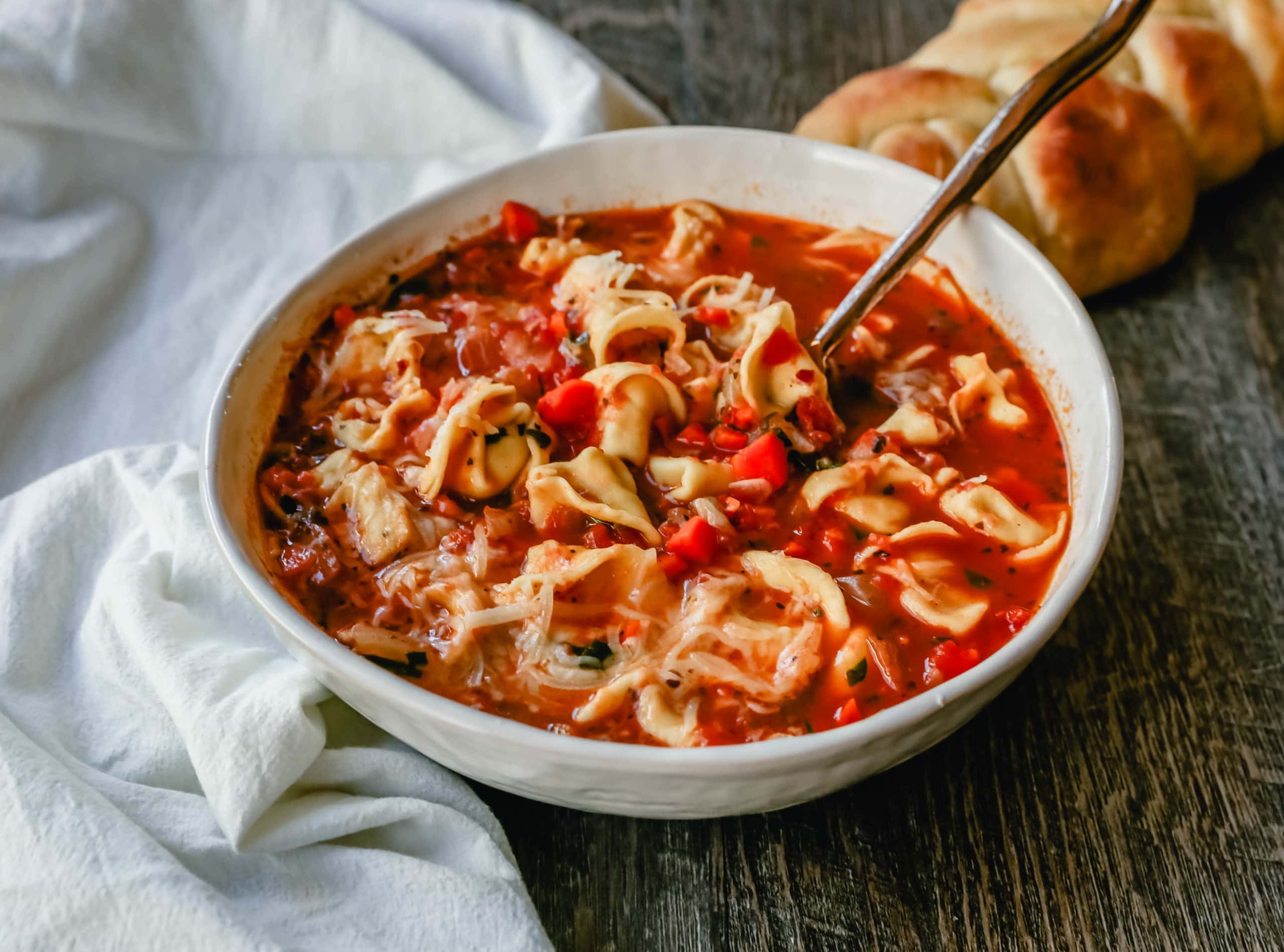 Tuscan Tortellini Vegetable Soup Robust vegetable soup with onions, garlic, carrots, tomatoes, basil, oregano, in a warm broth with creamy cheese tortellini and fresh parmesan cheese. The best tortellini soup! www.modernhoney.com #soup #tortellinisoup