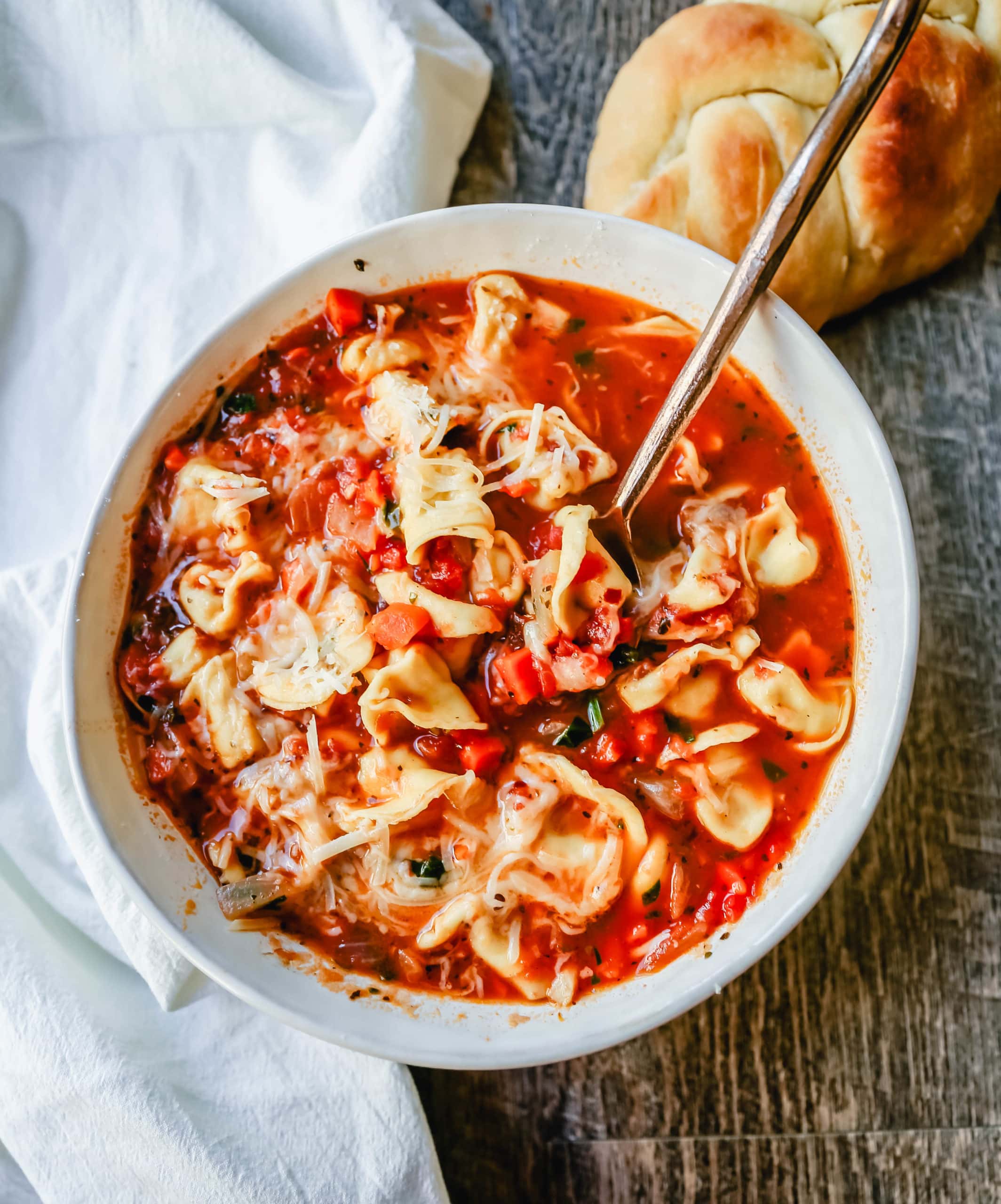 Tuscan Tortellini Vegetable Soup Robust vegetable soup with onions, garlic, carrots, tomatoes, basil, oregano, in a warm broth with creamy cheese tortellini and fresh parmesan cheese. The best tortellini soup! www.modernhoney.com #soup #tortellinisoup