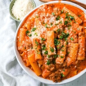 "Date Me" Creamy Sausage Rigatoni Pasta Homemade rich and creamy tomato cream and sausage sauce tossed with rigatoni and topped with parmesan cheese. The best creamy sausage rigatoni pasta! #pasta #dinner