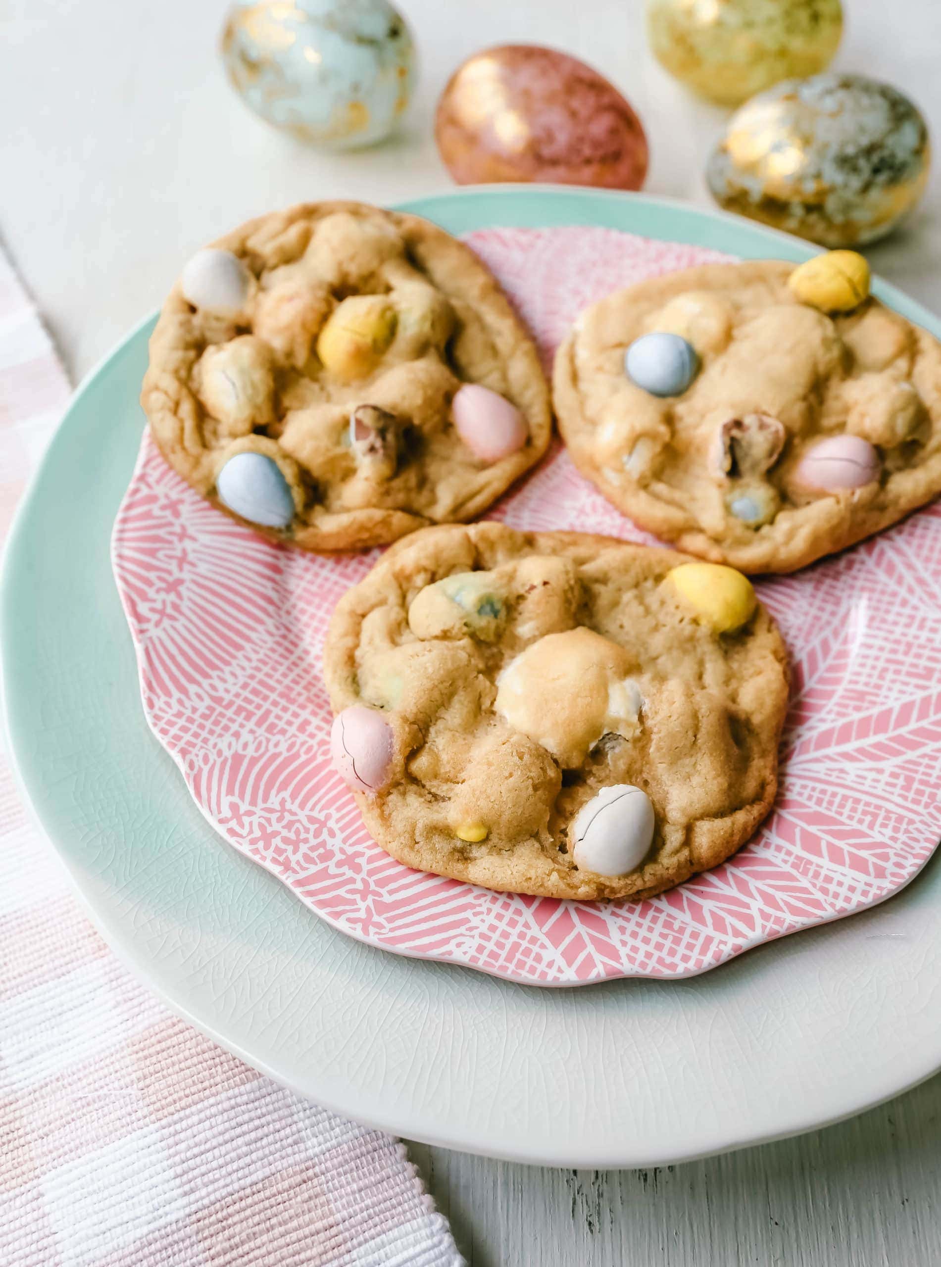 Chocolate Cadbury Egg Cookies A White Chocolate Chip and Famous Chocolate Mini Cadbury Eggs Cookie. Soft and chewy centers with crispy edges and decadent mini Cadbury eggs. A perfect Easter cookie! www.modernhoney.com #cookie #cookies #eastercookie #cadburyeggs