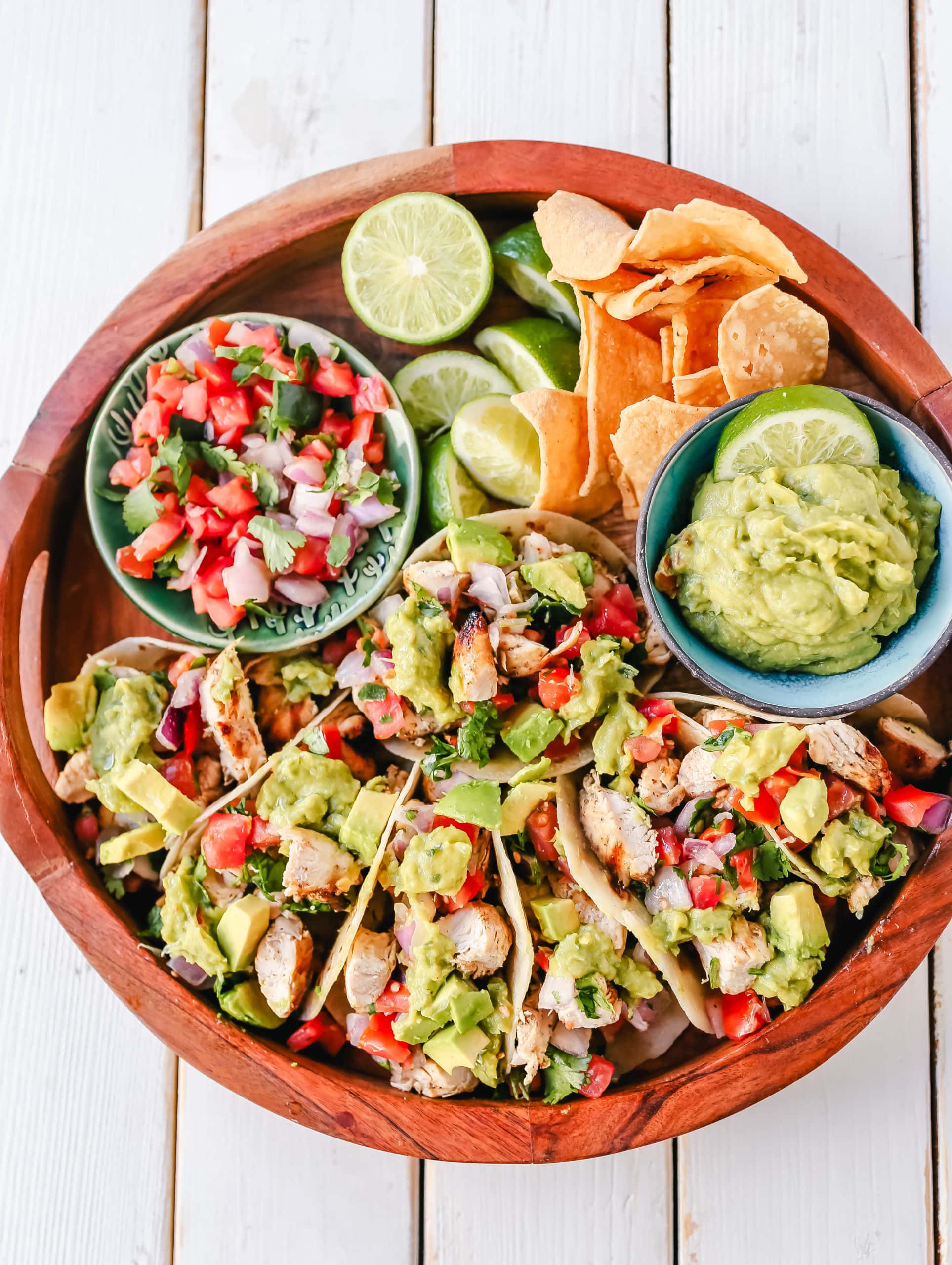 Grilled Chicken Tacos with Guacamole. Marinated grilled chicken with fresh lime and Mexican spices topped with pico de gallo and fresh guacamole. The best grilled chicken tacos! www.modernhoney.com #tacos #tacotuesday #chickentacos