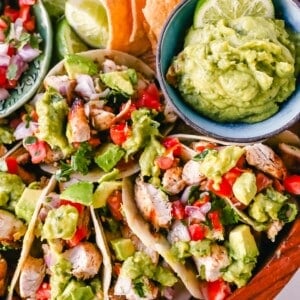 Grilled Chicken Tacos with Guacamole. Marinated grilled chicken with fresh lime and Mexican spices topped with pico de gallo and fresh guacamole. The best grilled chicken tacos! www.modernhoney.com #tacos #tacotuesday #chickentacos