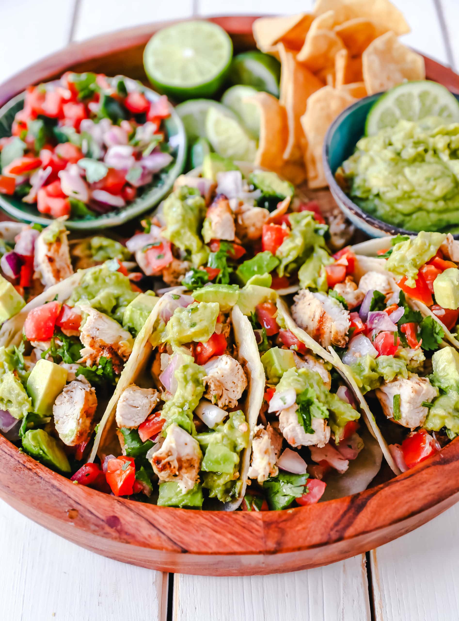 Grilled Chicken Tacos with Guacamole. Marinated grilled chicken with fresh lime and Mexican spices topped with pico de gallo and fresh guacamole. The best grilled chicken tacos! www.modernhoney.com #tacos #tacotuesday #chickentacos