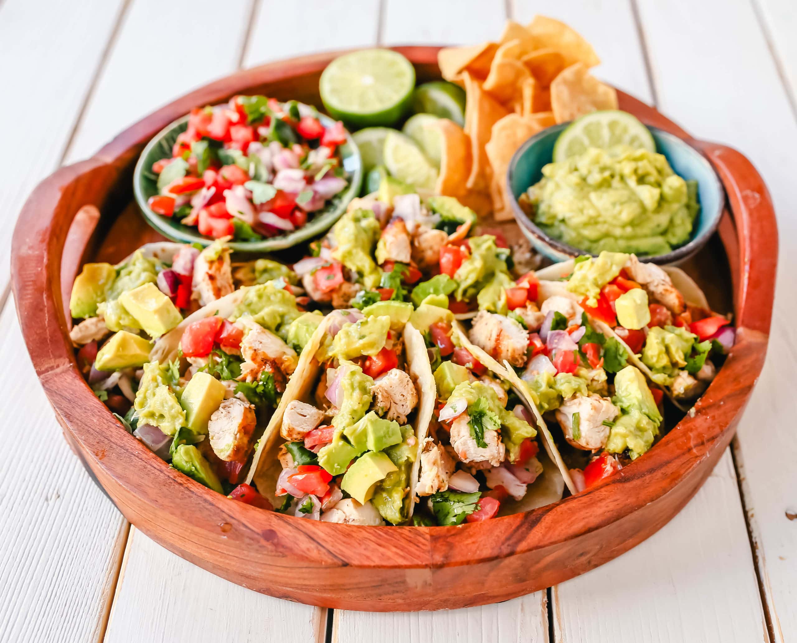 Grilled Chicken Tacos with Guacamole. Marinated grilled chicken with fresh lime and Mexican spices topped with pico de gallo and fresh guacamole. The best grilled chicken tacos! www.modernhoney.com #tacos #tacotuesday #chickentacos