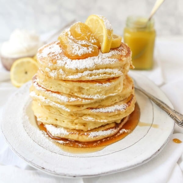 Lemon Ricotta Pancakes Creamy, fluffy lemon ricotta pancakes made with fresh ricotta, buttermilk, fresh lemon zest, and juice. A mix between a pancake and a crepe with a melt-in-your-mouth soft texture. www.modernhoney.com #pancakes #lemonricottapancakes #brunch #breakfast