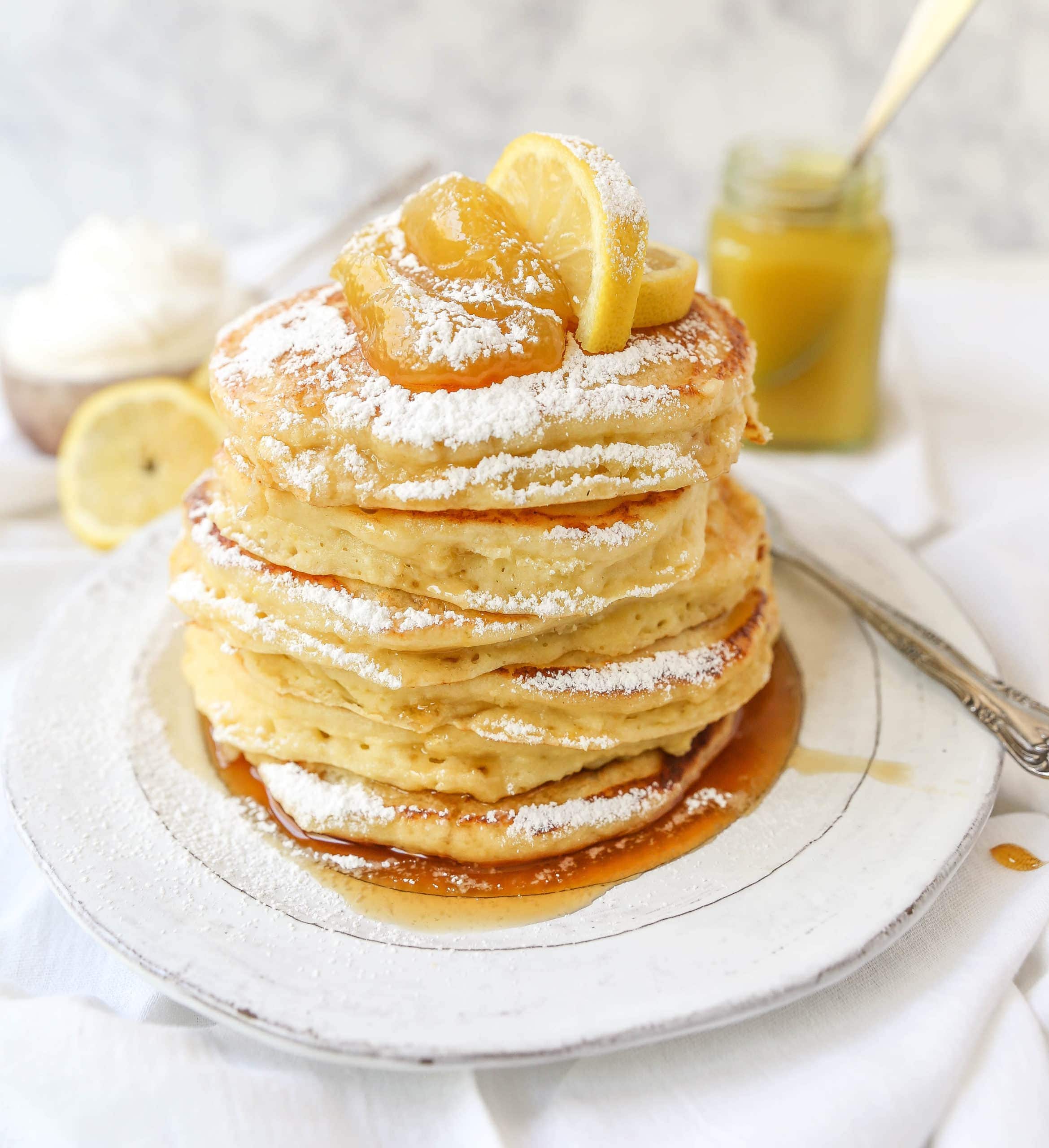 Lemon Ricotta Pancakes Creamy, fluffy lemon ricotta pancakes made with fresh ricotta, buttermilk, fresh lemon zest, and juice. A mix between a pancake and a crepe with a melt-in-your-mouth soft texture. www.modernhoney.com #pancakes #lemonricottapancakes #brunch #breakfast