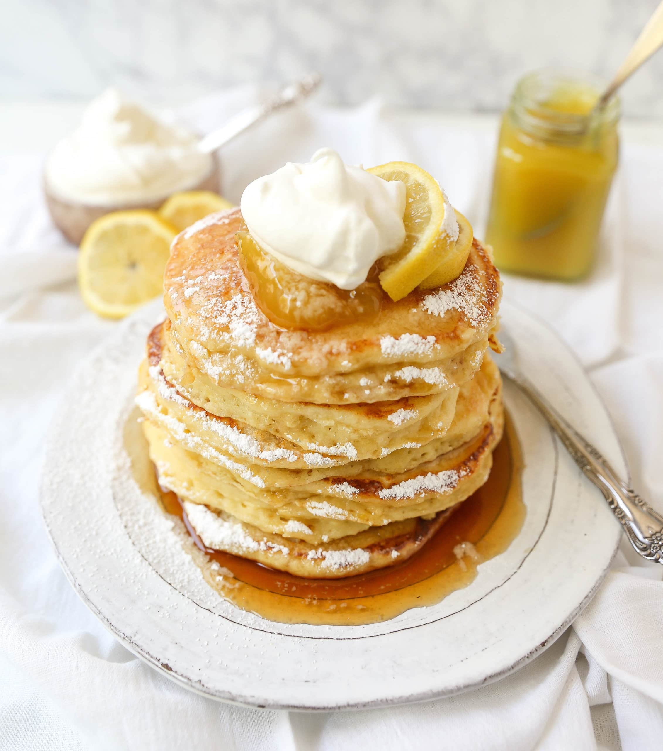 Lemon Ricotta Pancakes Creamy, fluffy lemon ricotta pancakes made with fresh ricotta, buttermilk, fresh lemon zest, and juice. A mix between a pancake and a crepe with a melt-in-your-mouth soft texture. www.modernhoney.com #pancakes #lemonricottapancakes #brunch #breakfast