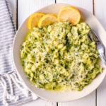 Shredded Sautéed Zucchini with Parmesan. Simple shredded fresh zucchini sauteed until tender and topped with salt, pepper, garlic, and parmesan cheese. This zucchini recipe pairs so well with beef and chicken. #zucchini #sidedish #vegetables