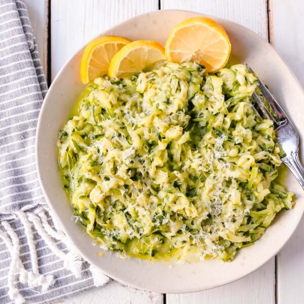 Shredded Sautéed Zucchini with Parmesan. Simple shredded fresh zucchini sauteed until tender and topped with salt, pepper, garlic, and parmesan cheese. This zucchini recipe pairs so well with beef and chicken. #zucchini #sidedish #vegetables