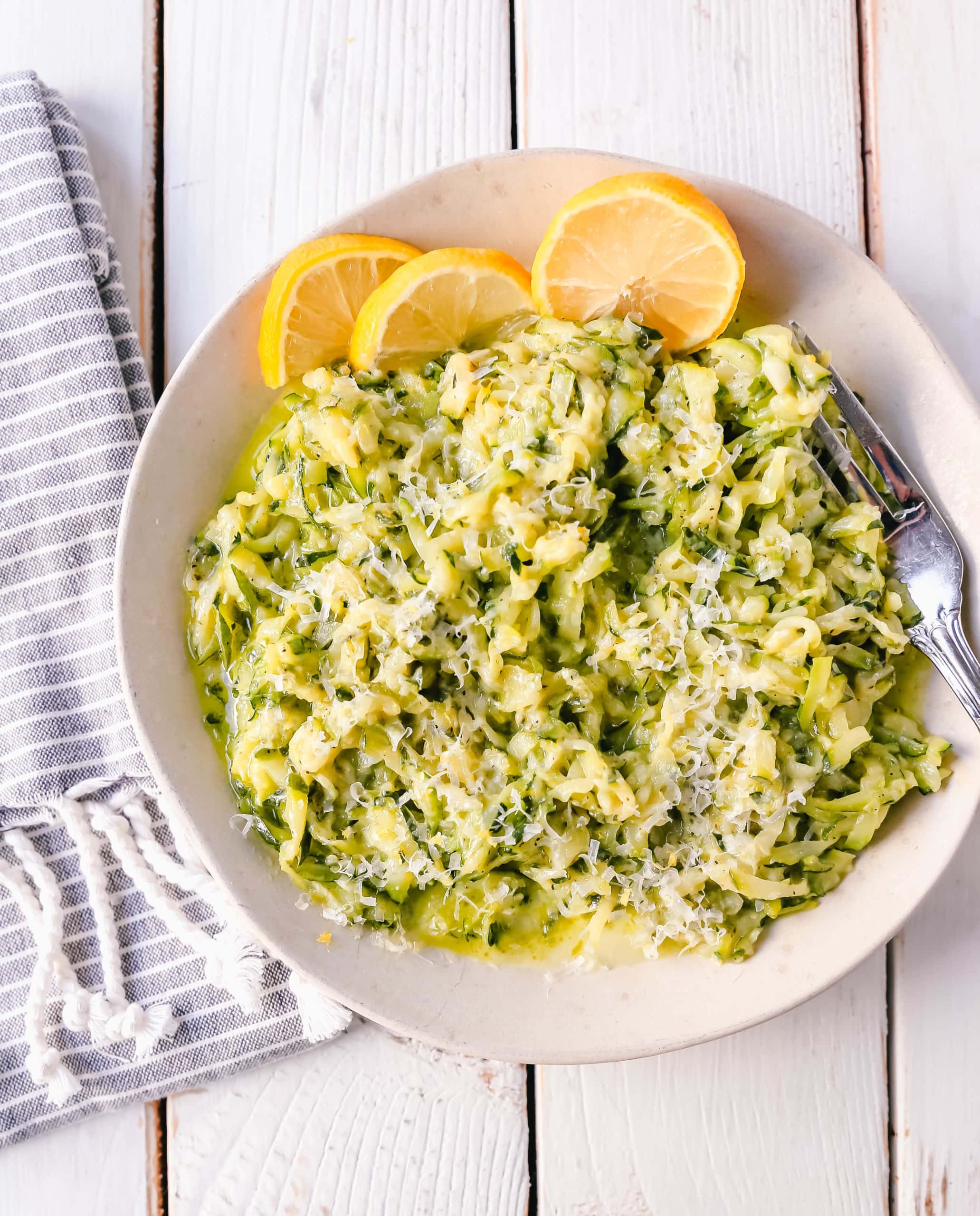 Shredded Sautéed Zucchini with Parmesan. Simple shredded fresh zucchini sauteed until tender and topped with salt, pepper, garlic, and parmesan cheese. This zucchini recipe pairs so well with beef and chicken. #zucchini #sidedish #vegetables