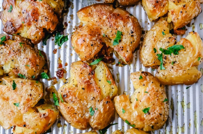 Crispy Smashed Potatoes. Crispy smashed potatoes with creamy, fluffy centers and crispy outsides. Petite potatoes topped with olive oil, salted butter, salt, and pepper and baked until crispy and topped with a garlic cheddar sour cream dip. The best smashed potatoes recipe!