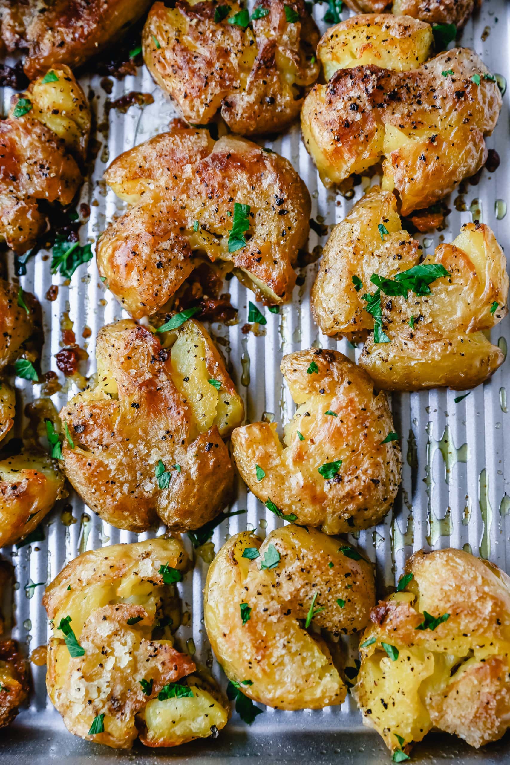 Crispy Smashed Potatoes. Crispy smashed potatoes with creamy, fluffy centers and crispy outsides. Petite potatoes topped with olive oil, salted butter, salt, and pepper and baked until crispy and topped with a garlic cheddar sour cream dip. The best smashed potatoes recipe! 