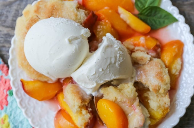 Peach Cobbler. The Best Peach Cobbler Recipe! Fresh peaches tossed with a touch of sugar and topped with a homemade sweet and buttery topping that resembles a mix of a sugar cookie and a sweet biscuit.
