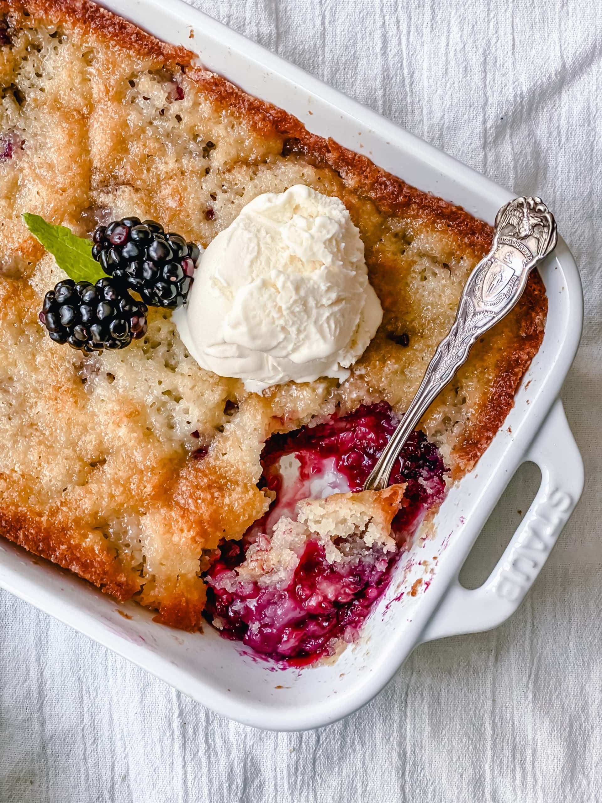 Blackberry Cobbler. A Texas favorite! This Blackberry Cobbler is made with a sweet, buttery crust with fresh sweetened blackberries and topped with vanilla bean ice cream. The perfect summer dessert recipe!