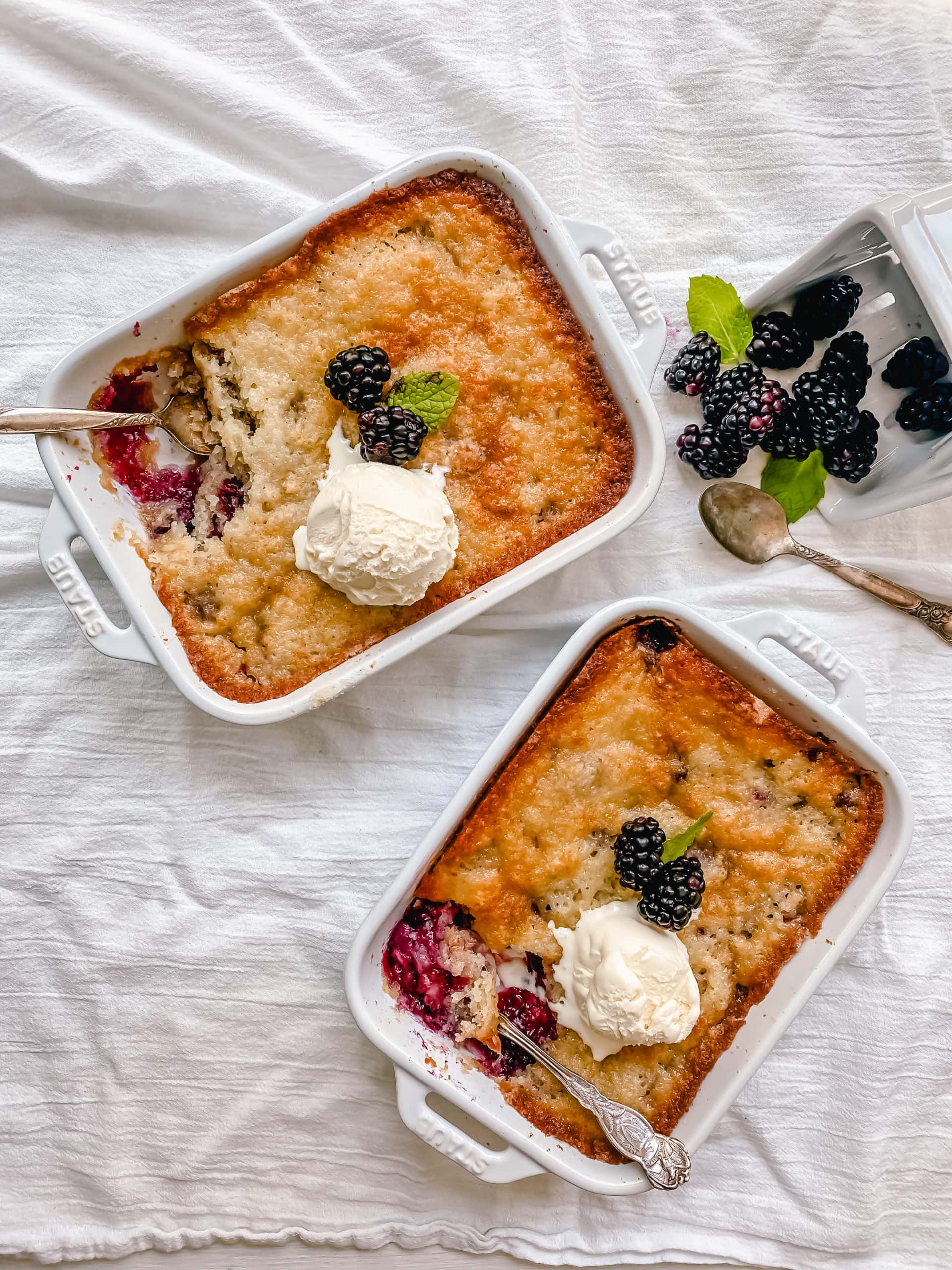 Blackberry Cobbler. A Texas favorite! This Blackberry Cobbler is made with a sweet, buttery crust with fresh sweetened blackberries and topped with vanilla bean ice cream. The perfect summer dessert recipe!