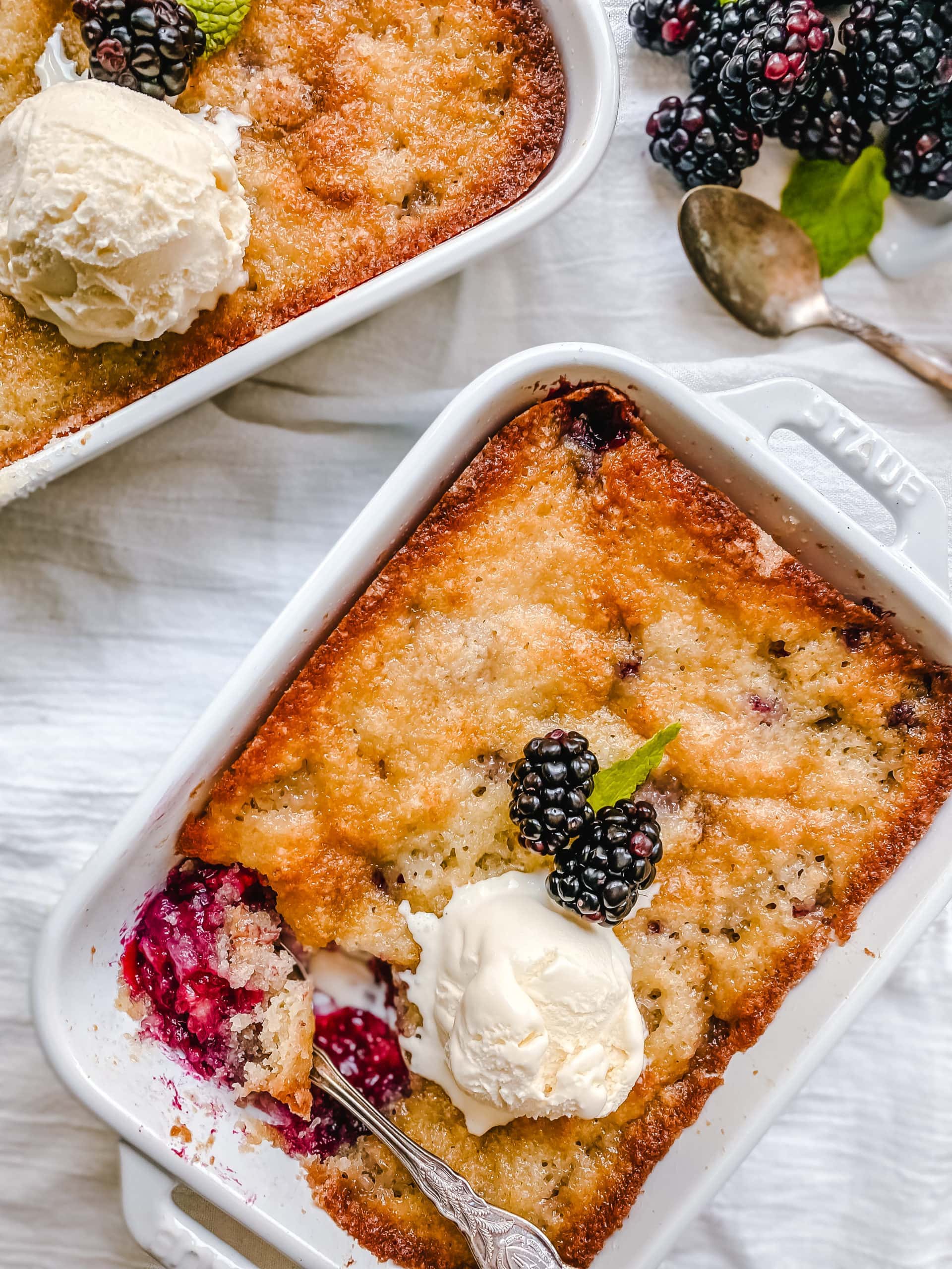 Blackberry Cobbler. A Texas favorite! This Blackberry Cobbler is made with a sweet, buttery crust with fresh sweetened blackberries and topped with vanilla bean ice cream. The perfect summer dessert recipe!