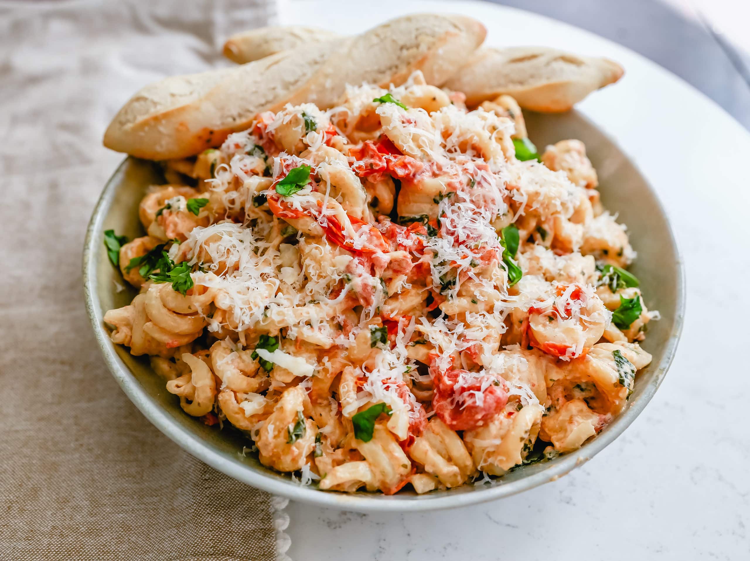 Boursin Cheese Baked TikTok Pasta Freshly cooked pasta tossed with baked Boursin cheese, tomatoes, garlic, spices, and parmesan cheese. This easy-baked pasta recipe will knock your socks off! #pasta #bakedpasta #tiktokpasta