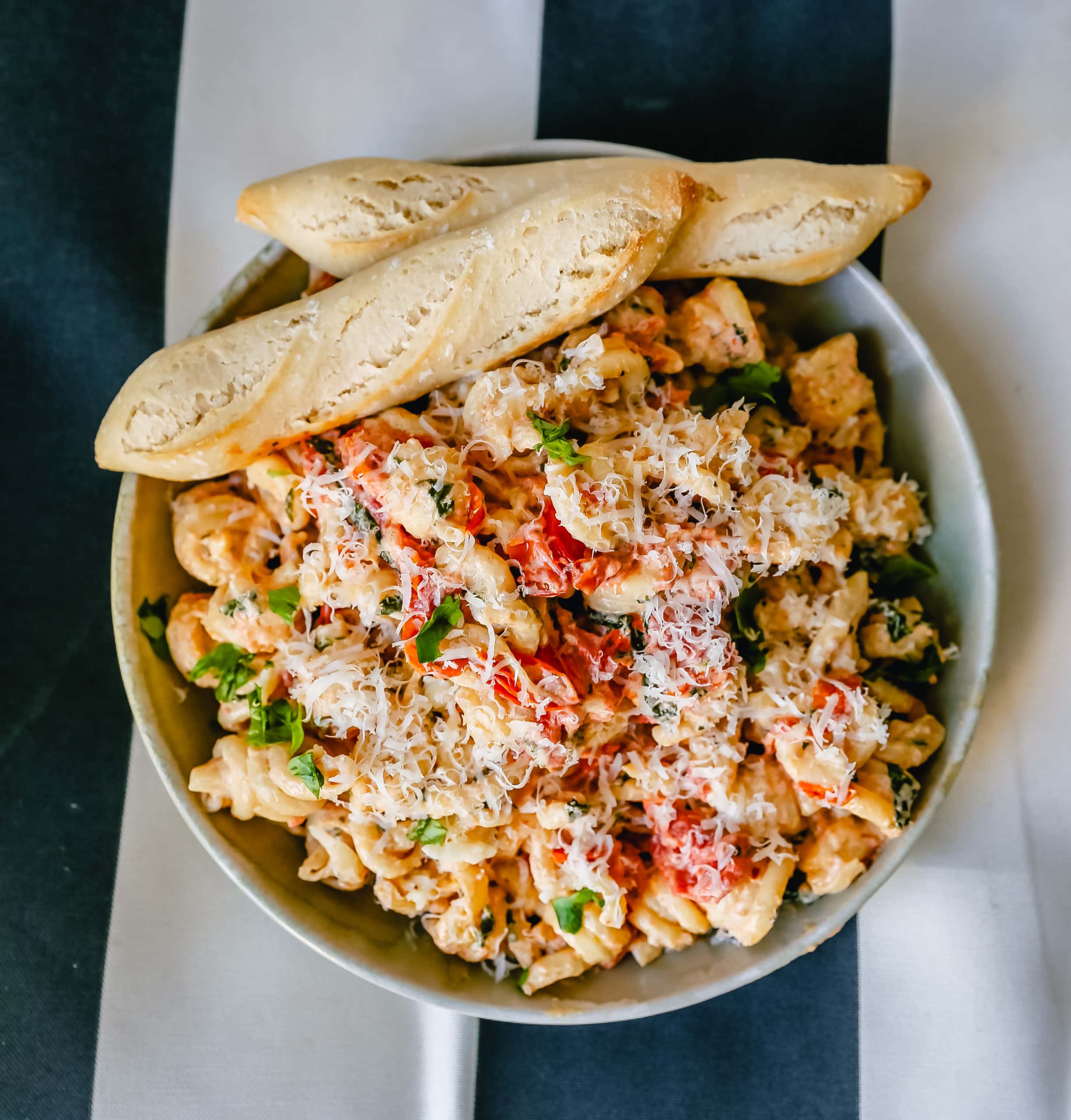 Boursin Cheese Baked TikTok Pasta Freshly cooked pasta tossed with baked Boursin cheese, tomatoes, garlic, spices, and parmesan cheese. This easy-baked pasta recipe will knock your socks off! #pasta #bakedpasta #tiktokpasta