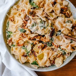 Creamy Bowtie Pasta with Sundried Tomatoes Bowtie Pasta tossed with a garlic sundried tomato cream sauce with artichoke hearts and parmesan cheese and crunchy toasted walnuts. A quick 20-minute weeknight meal. #pasta #dinner
