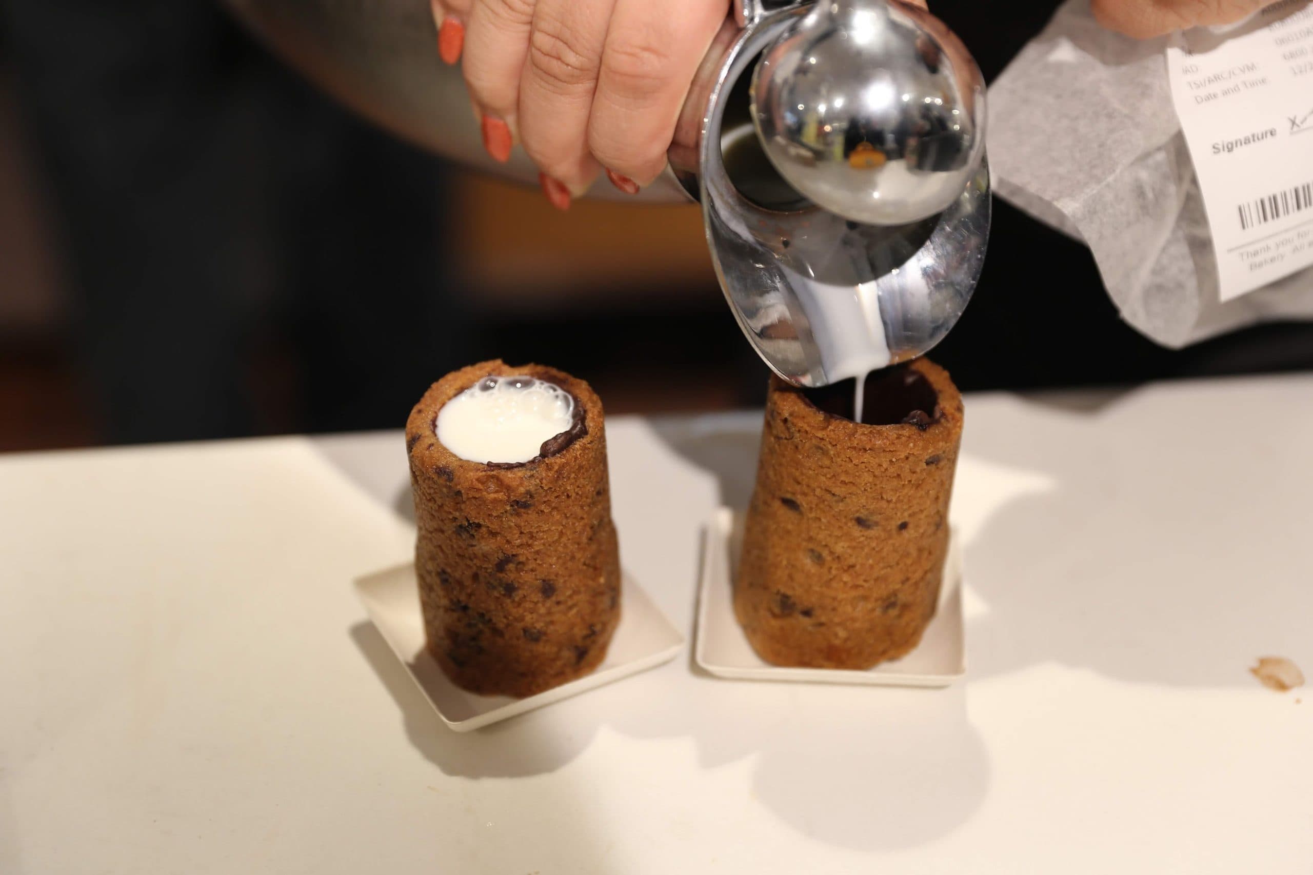 Milk and Cookie Shots The famous Milk and Cookie Shots were made famous at New York City Dominique Ansel Bakery. This soft chocolate chip cookie is shaped into a shot, baked until warm and gooey, lined with chocolate, and served with milk inside. If you love cookies and milk, this is the dessert for you!