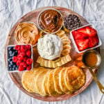 Breakfast Pancake Board. The perfect breakfast for entertaining! Homemade buttermilk pancakes topped with all of your favorite toppings -- fresh berries, whipped cream, homemade syrup, Nutella, chocolate chips, peanut butter, and more. 