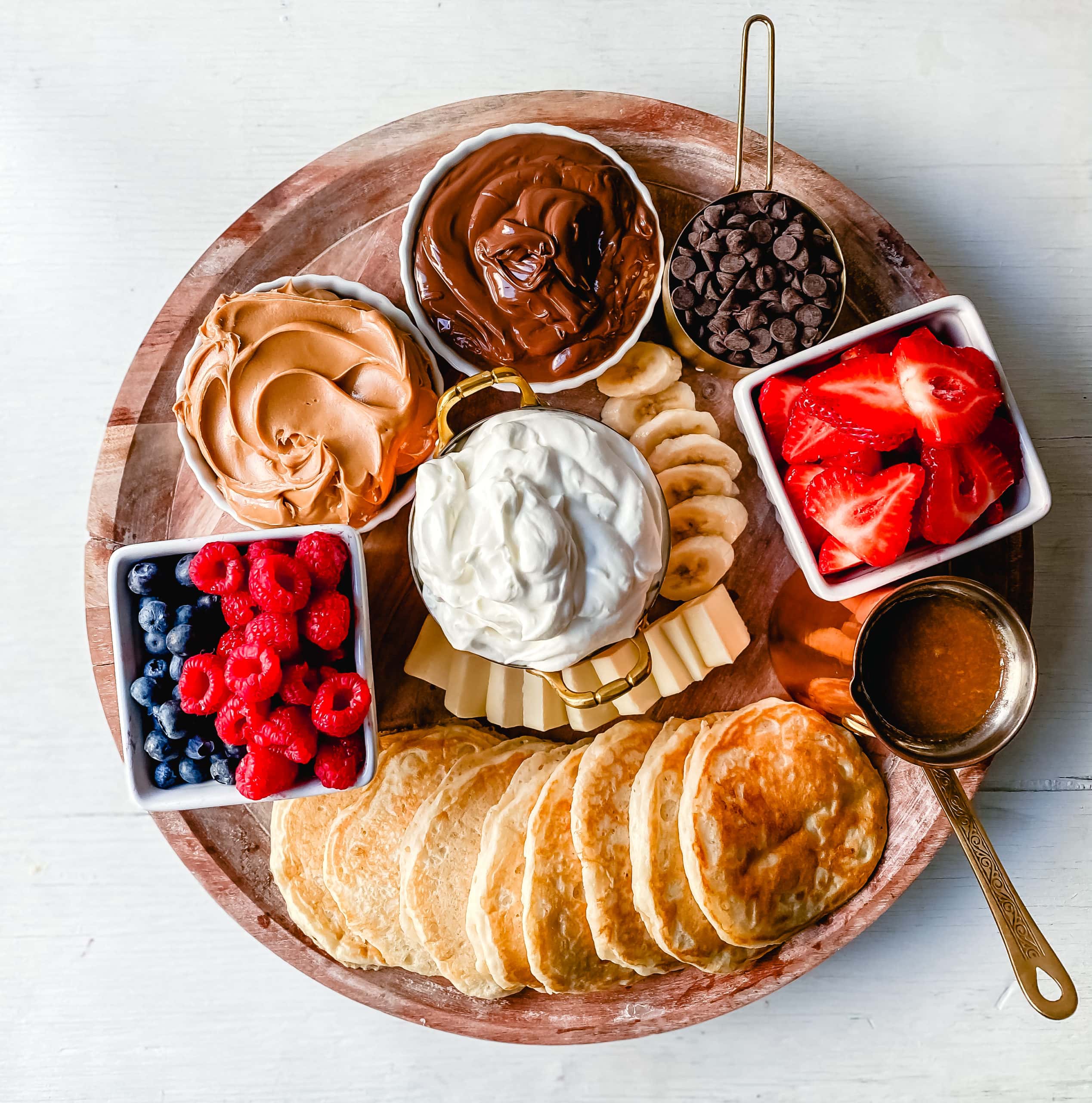 Breakfast Pancake Board. The perfect breakfast for entertaining! Homemade buttermilk pancakes topped with all of your favorite toppings -- fresh berries, whipped cream, homemade syrup, Nutella, chocolate chips, peanut butter, and more. 