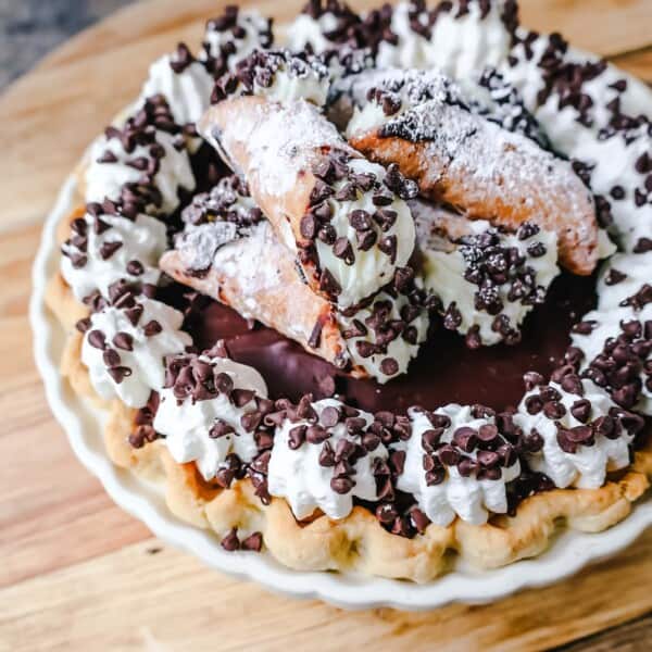 Best Cannoli Pie Recipe. The popular Italian dessert -- the famous Cannoli -- but made into a pie. A creamy sweet ricotta and cream cheese filling with mini chocolate chips, topped with chocolate ganache, and freshly whipped cream.