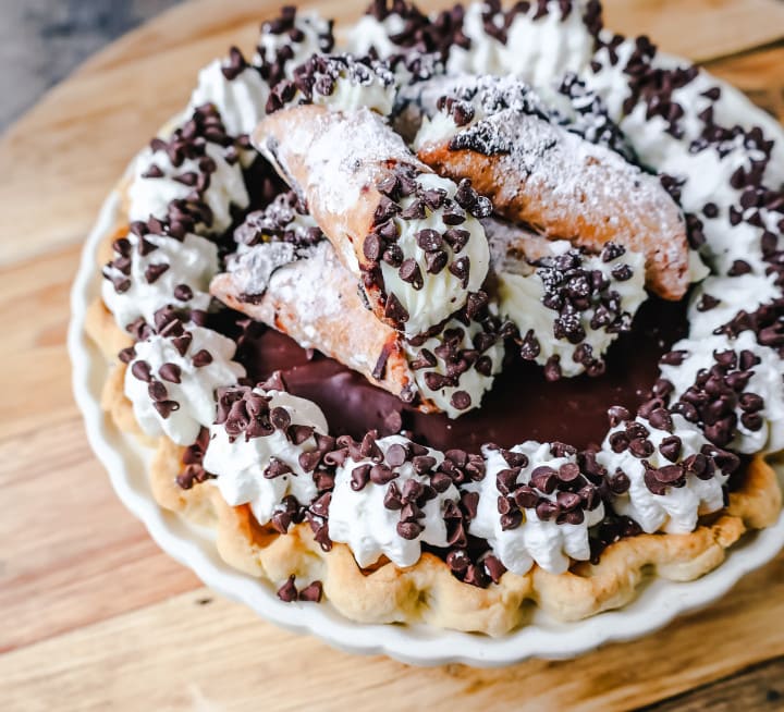 Best Cannoli Pie Recipe. The popular Italian dessert -- the famous Cannoli -- but made into a pie. A creamy sweet ricotta and cream cheese filling with mini chocolate chips, topped with chocolate ganache, and freshly whipped cream.