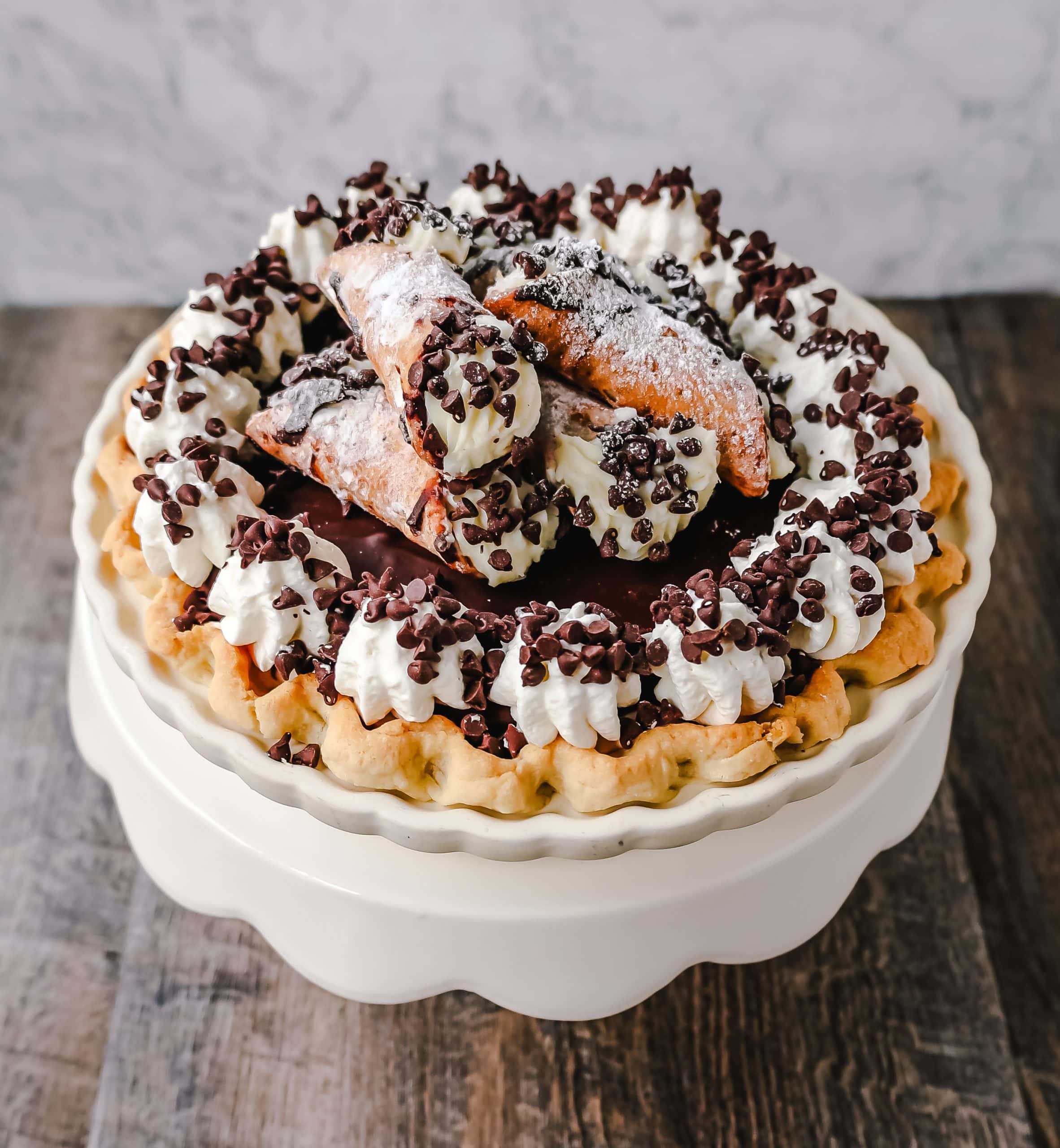Best Cannoli Pie Recipe The popular Italian dessert -- the famous Cannoli -- but made into a pie. A creamy sweet ricotta and cream cheese filling with mini chocolate chips, topped with chocolate ganache, and freshly whipped cream.
